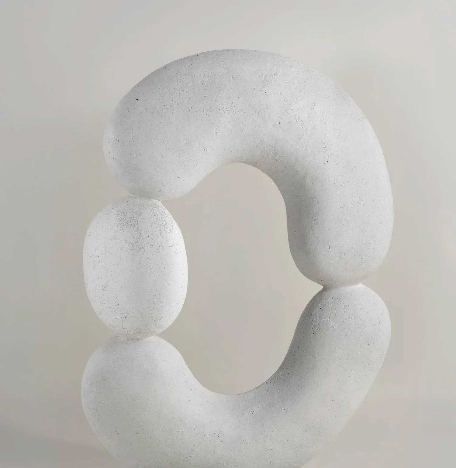 Abstract white sculptural form with organic curved shapes and hollow voids, rendered in smooth matte material by Humble Matter.