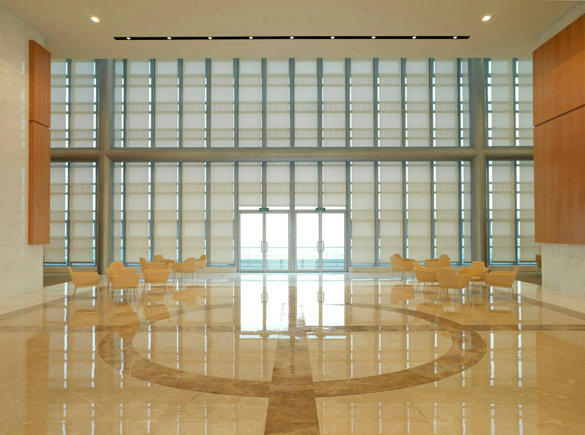 Minimalist interior with wooden flooring, glass block wall, and geometric furniture arrangement by IA.