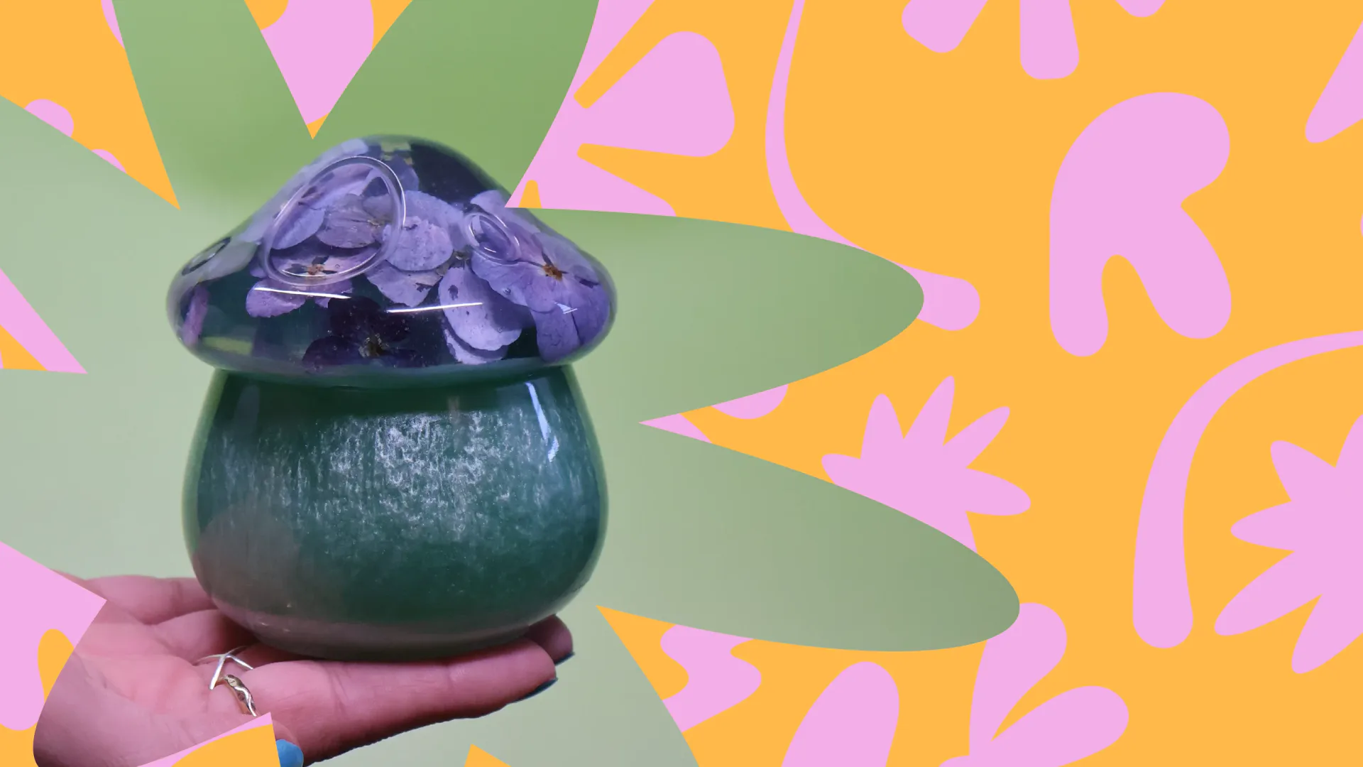 Sculptural ceramic vessel with purple crystalline glaze displayed on colorful geometric background by IRUSU Creation.