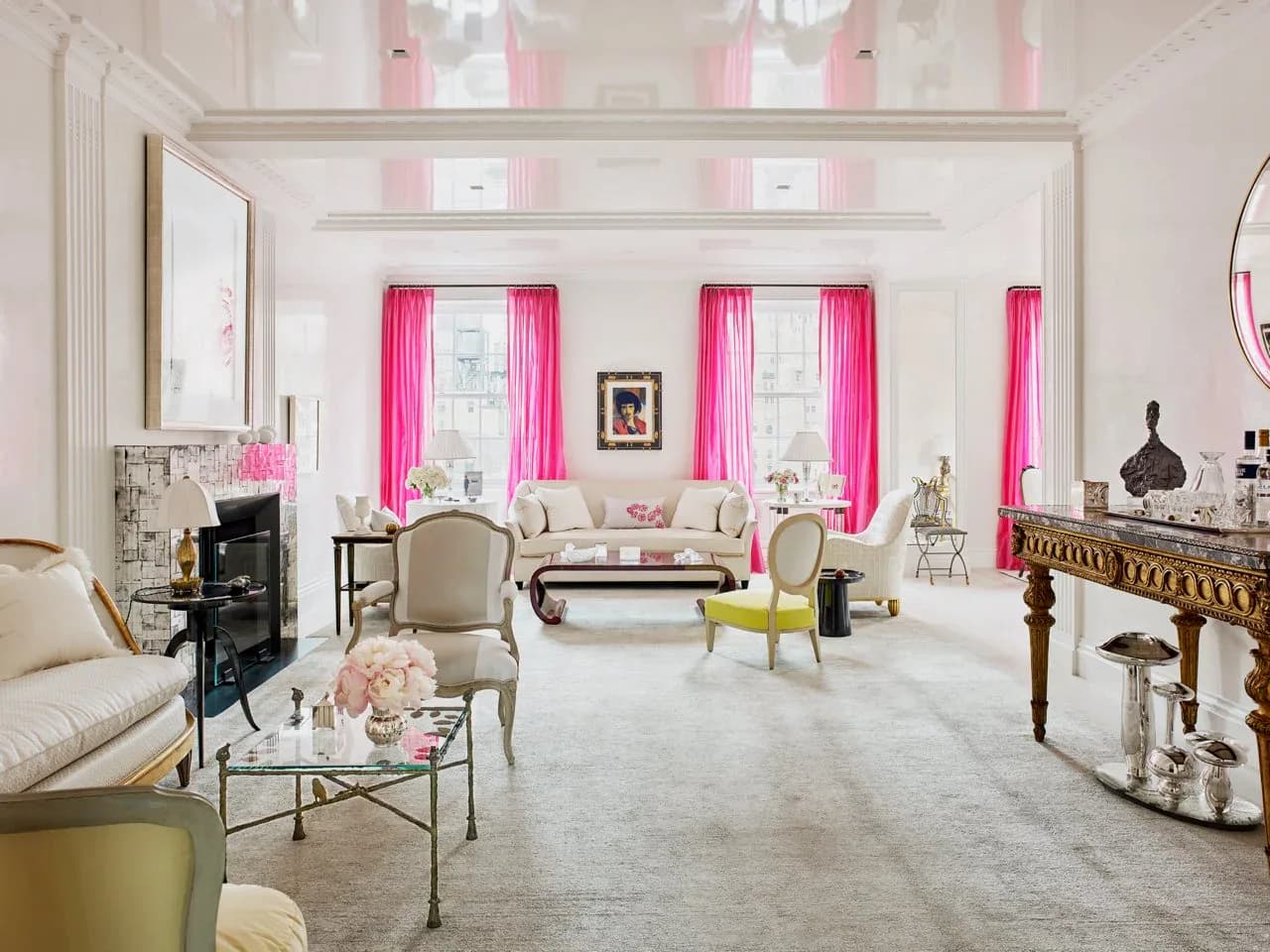 Luminous living room with soaring ceilings, hot-pink curtains, neutral furnishings, and refined finishes by J. Gordon Painted Finishes.
