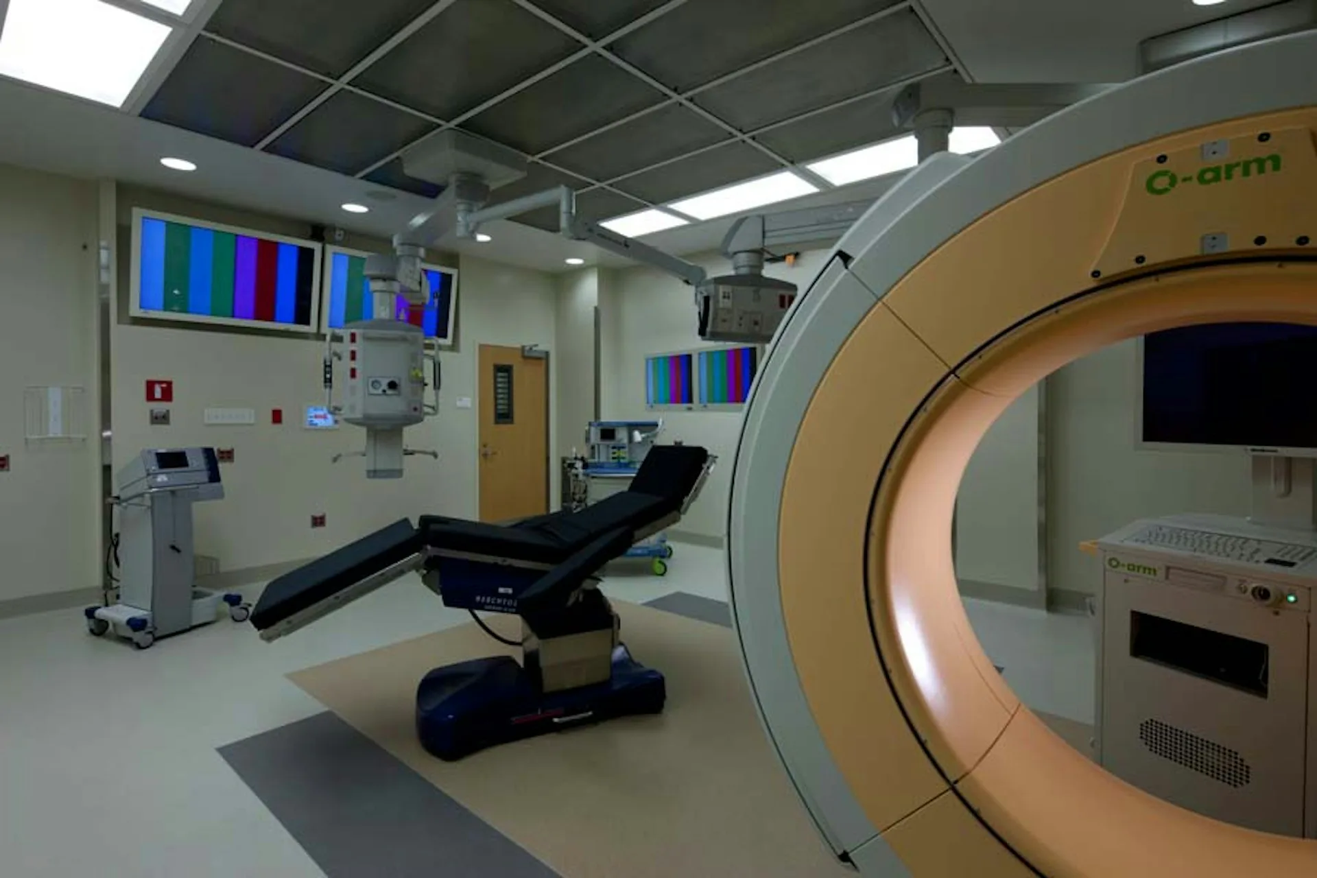 Medical imaging facility with large diagnostic scanner and examination chair, modern institutional interior by Jeffrey Berman Architect.
