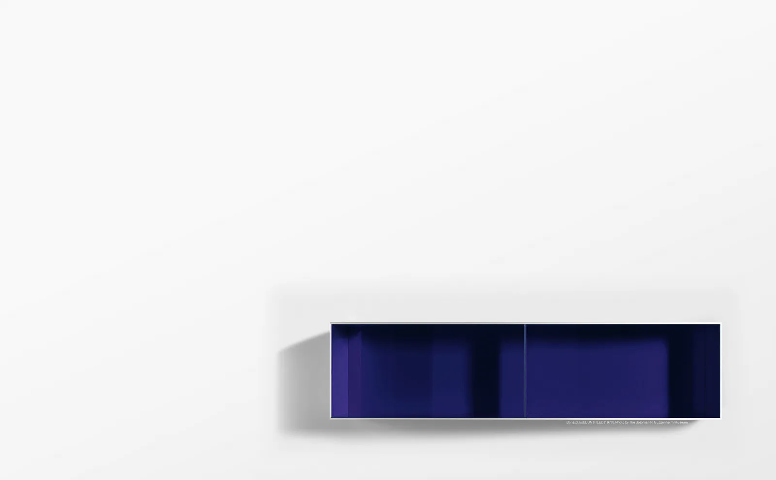Abstract minimalist rendering with dark navy horizontal rectangular form and soft shadow detail against pale background, by Joeb Moore & Partners.