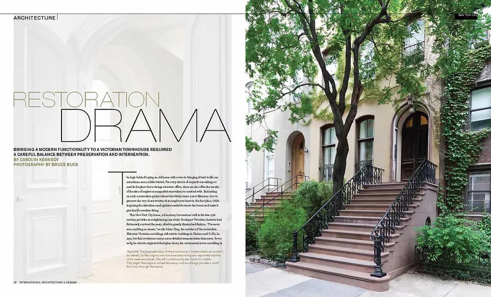 Restored brownstone facade with ivy-covered brick, arched windows, and grand entrance stairs, showcasing architectural restoration work by julian king architect.