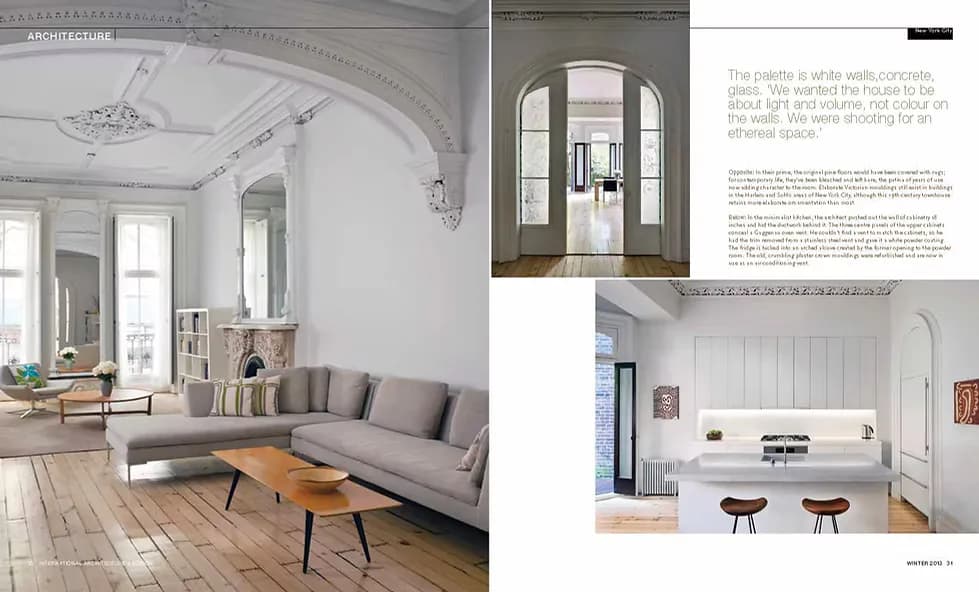 Bright Scandinavian-inspired living spaces with white walls, natural wood flooring, arched doorways, minimal furnishings, and soft gray upholstery by Julian King Architect.