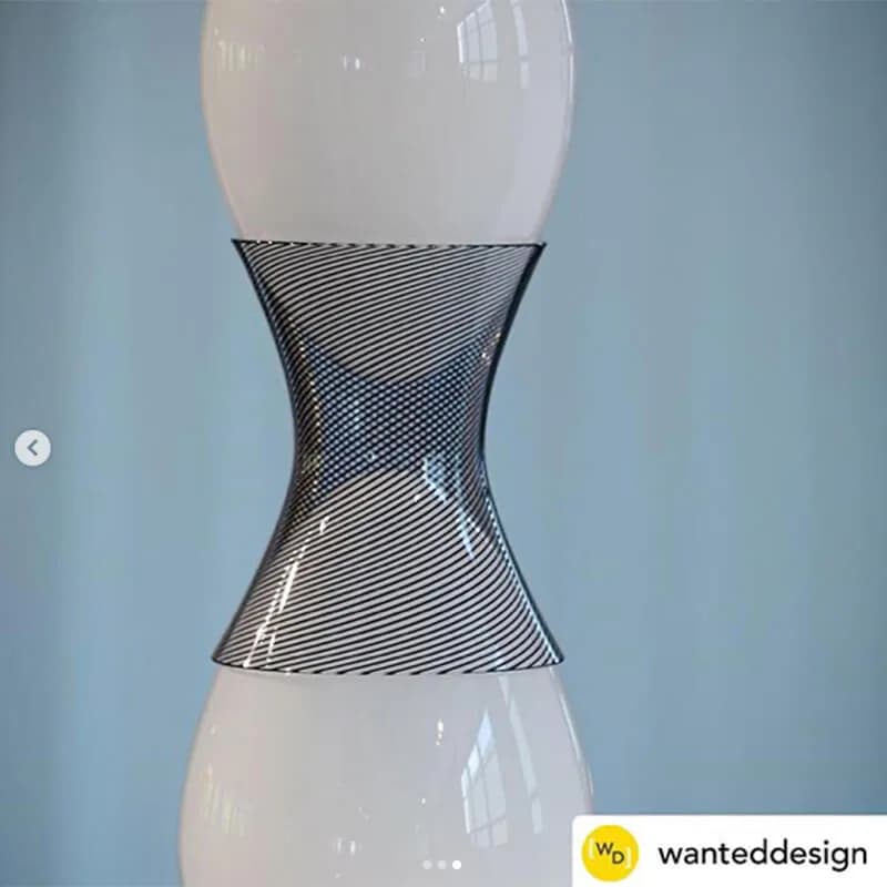 Sculptural lighting fixture with white blown-glass bulbous ends and geometric mesh middle section creating an hourglass silhouette by KEEP.