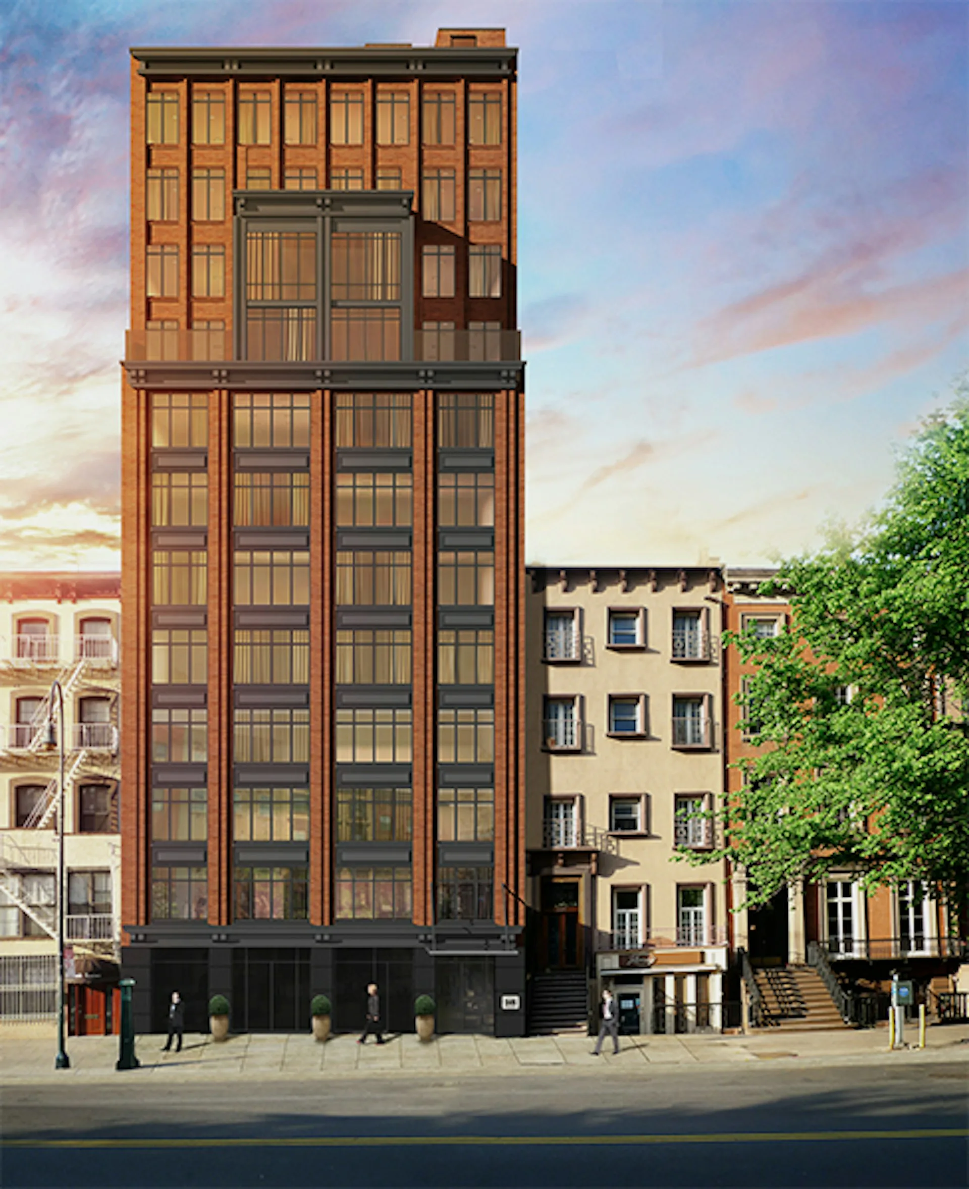 Tall brick tower building with geometric patterned facade and dark window frames, flanked by lower residential buildings with ivy, set against a sunset sky by Kutnicki Bernstein Architects.