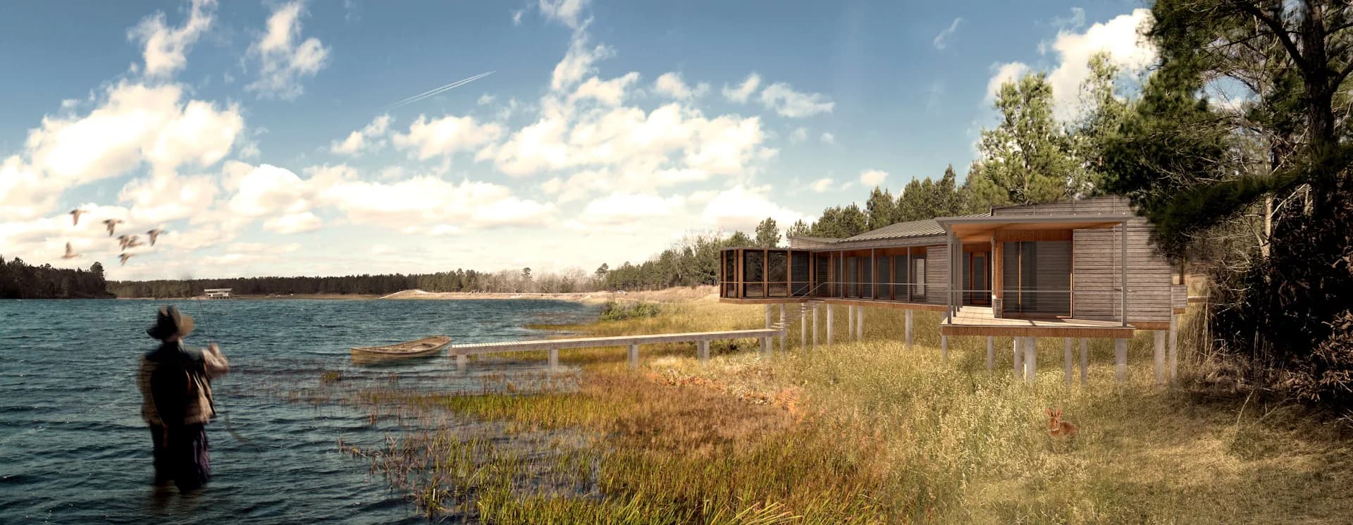 Waterfront residential structure with wooden exterior and large glazing set among golden marsh grasses, designed by Lang Architecture.