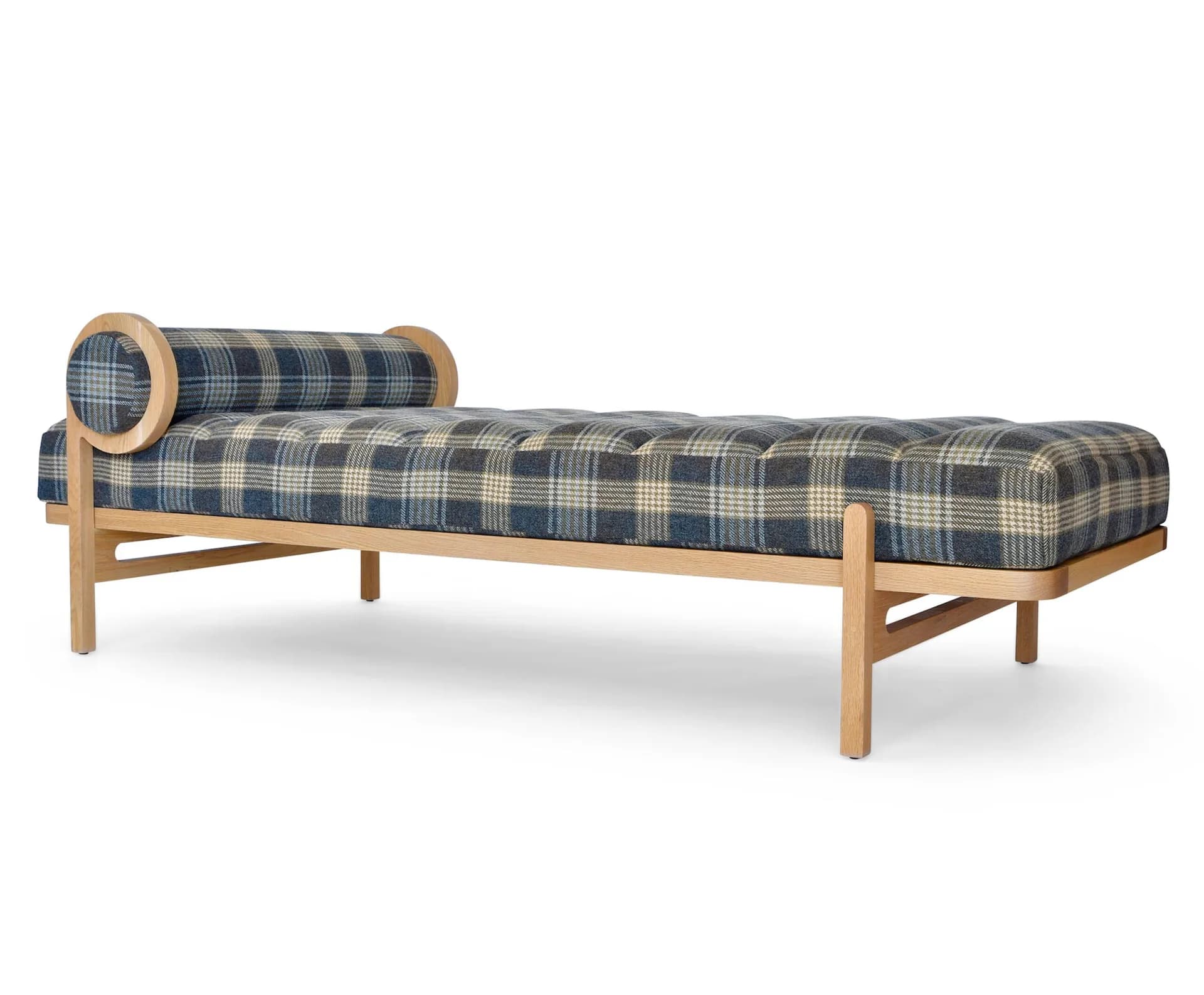 Wooden daybed with plaid upholstered cushioning and cylindrical bolster pillow, featuring tapered legs and natural wood frame by Last Ditch Design.