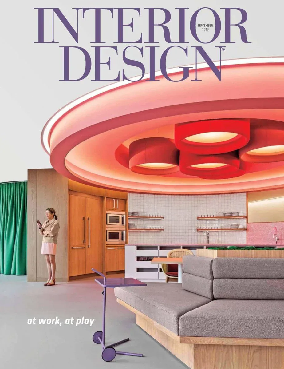 Modern open-plan interior with sculptural red ceiling feature, gray sectional sofa, wooden kitchen cabinetry, and pink accents by Lux Collaborative.