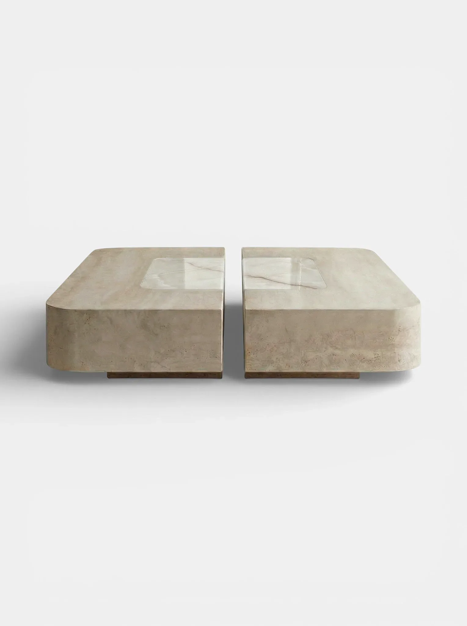 Two minimalist concrete modular furniture pieces with glass-top surfaces positioned side-by-side, rendered with soft studio lighting by Marbera.