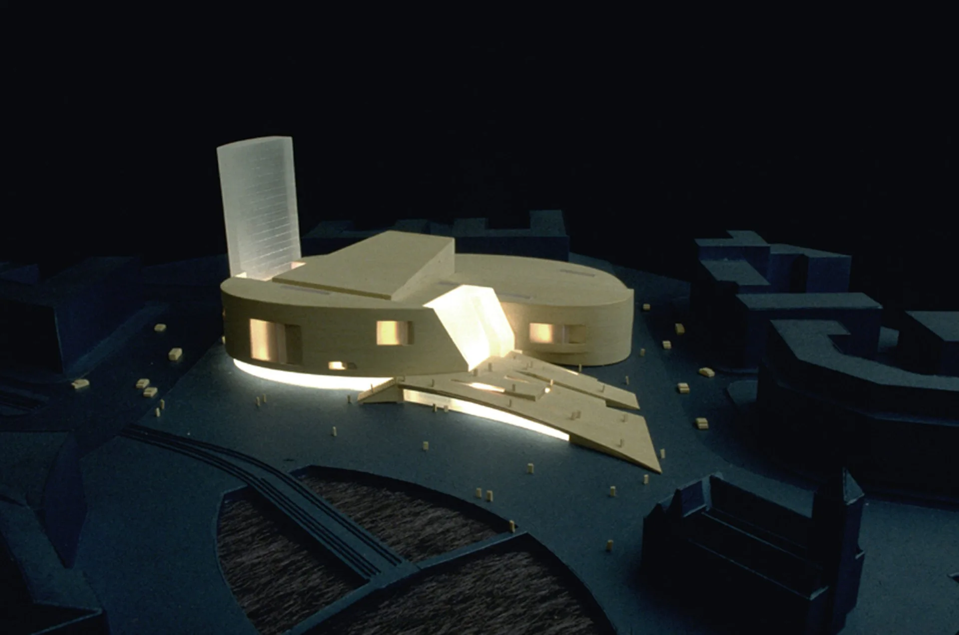 Architectural CGI rendering of a modern institutional building with cream-colored volumes, illuminated interiors, and dark landscaping by Marble Fairbanks.