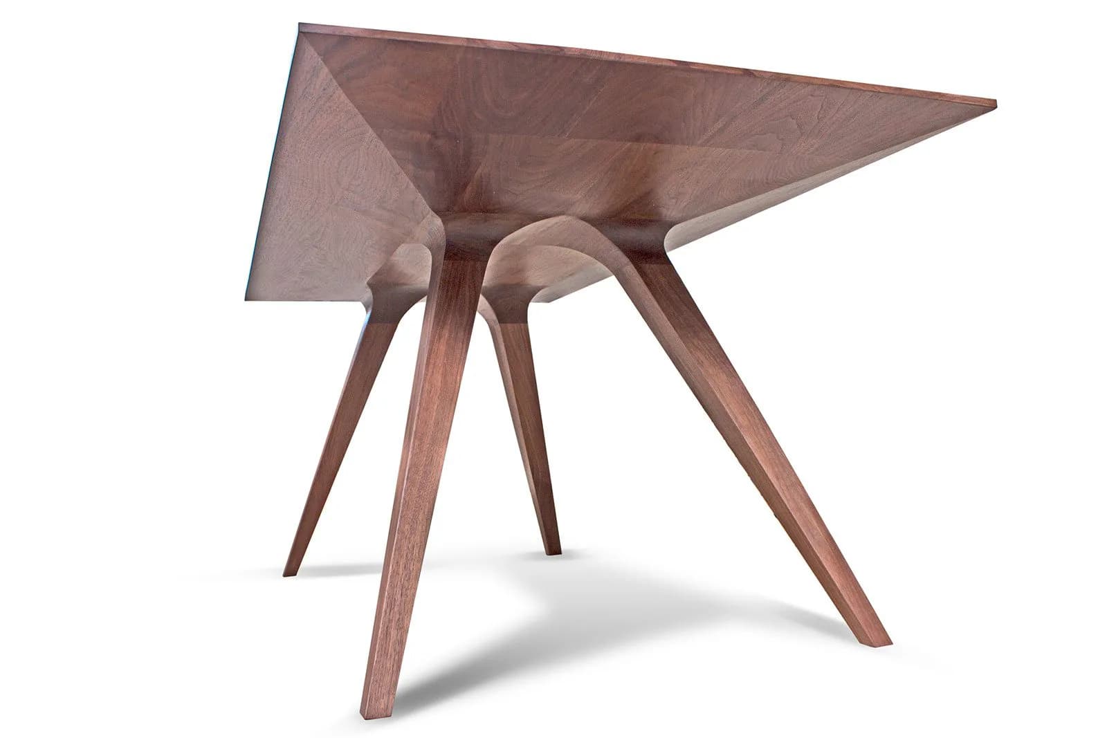 Minimalist wooden side table with triangular top and angled legs in warm walnut tones, rendered with soft studio lighting by Mark Jupiter.