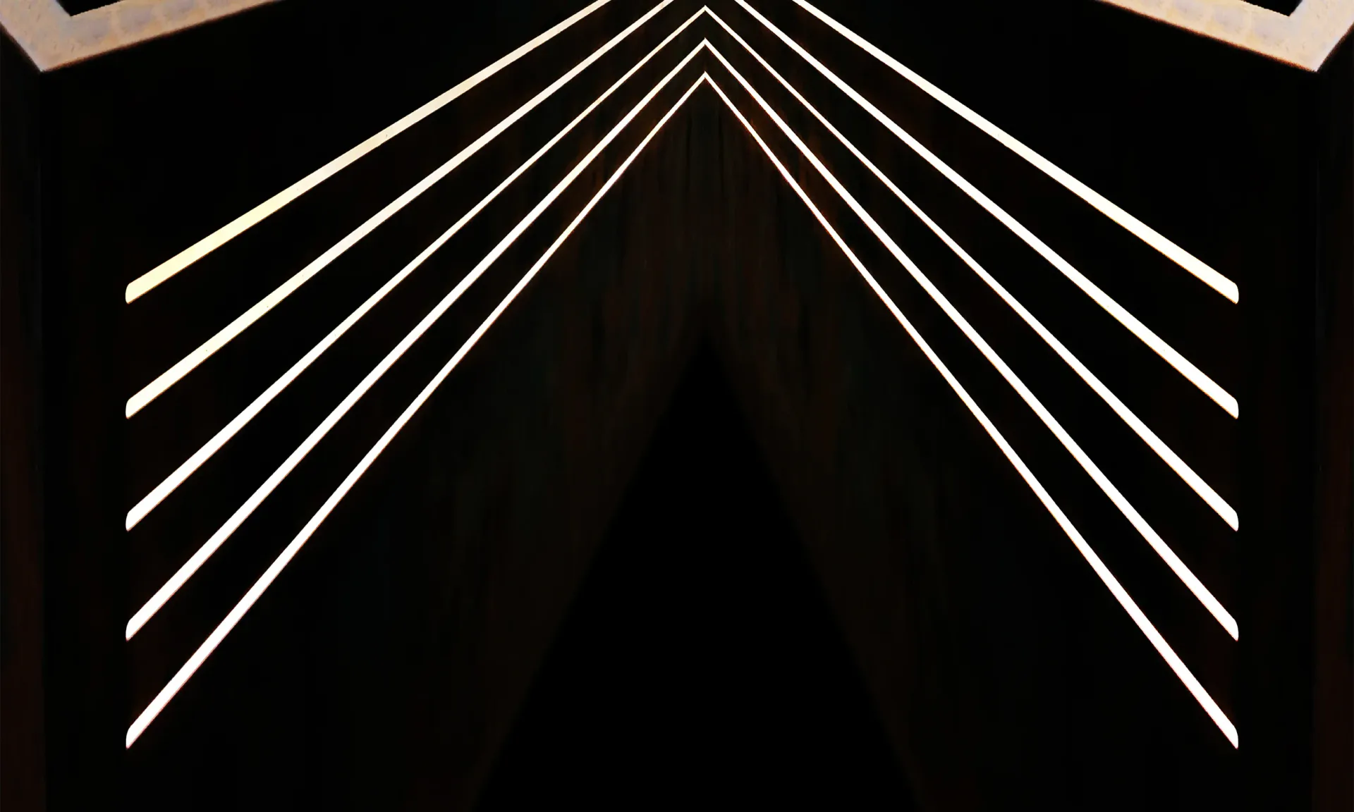 Geometric line drawing of converging white lines forming a chevron or arrow pattern against a black background, suggesting architectural perspective by MASTER Architectural Fabrication.