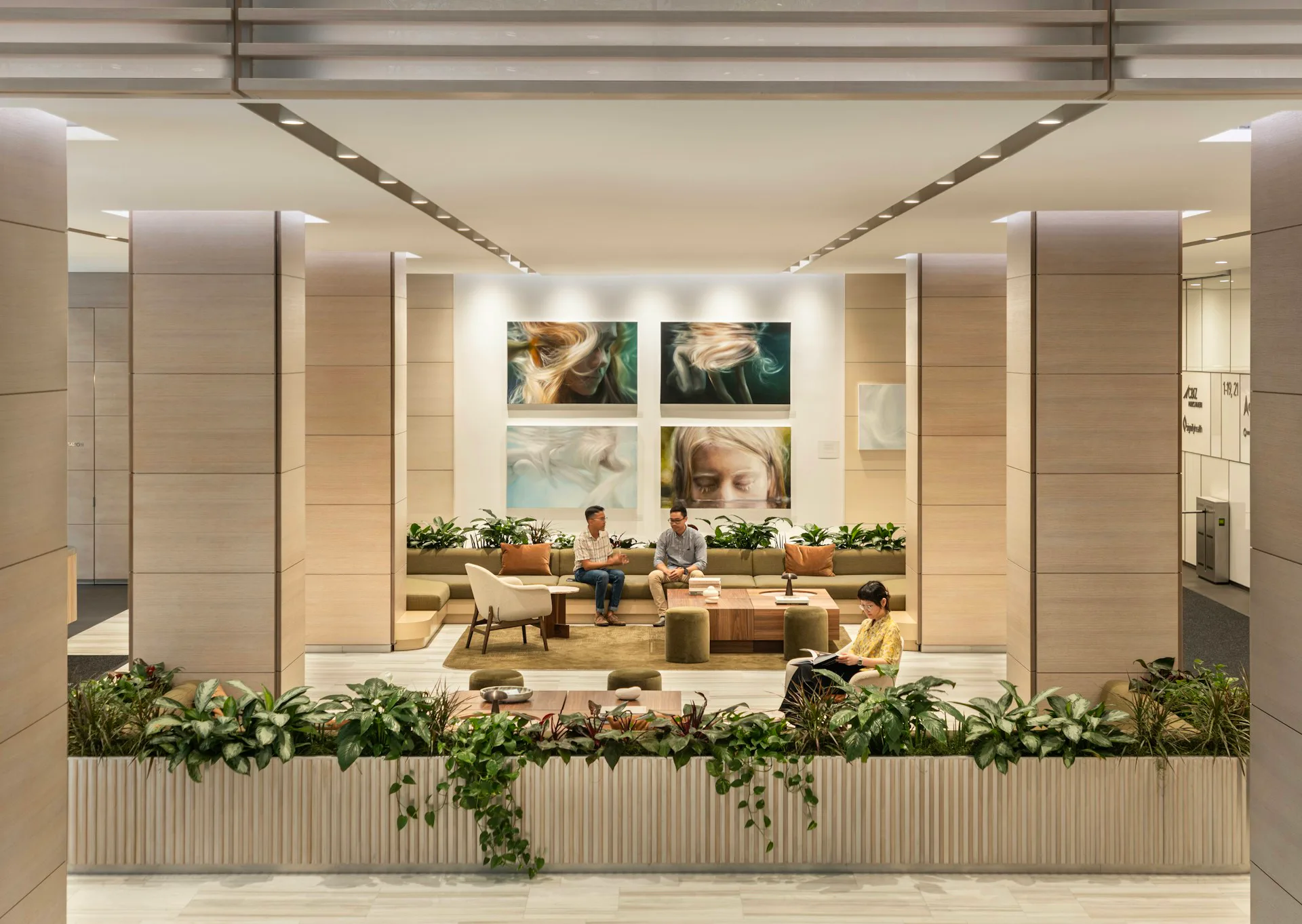 Modern retail storefront with warm wood paneling, linear ceiling details, potted plants, and framed artwork on back wall, designed by MdeAS Architects.