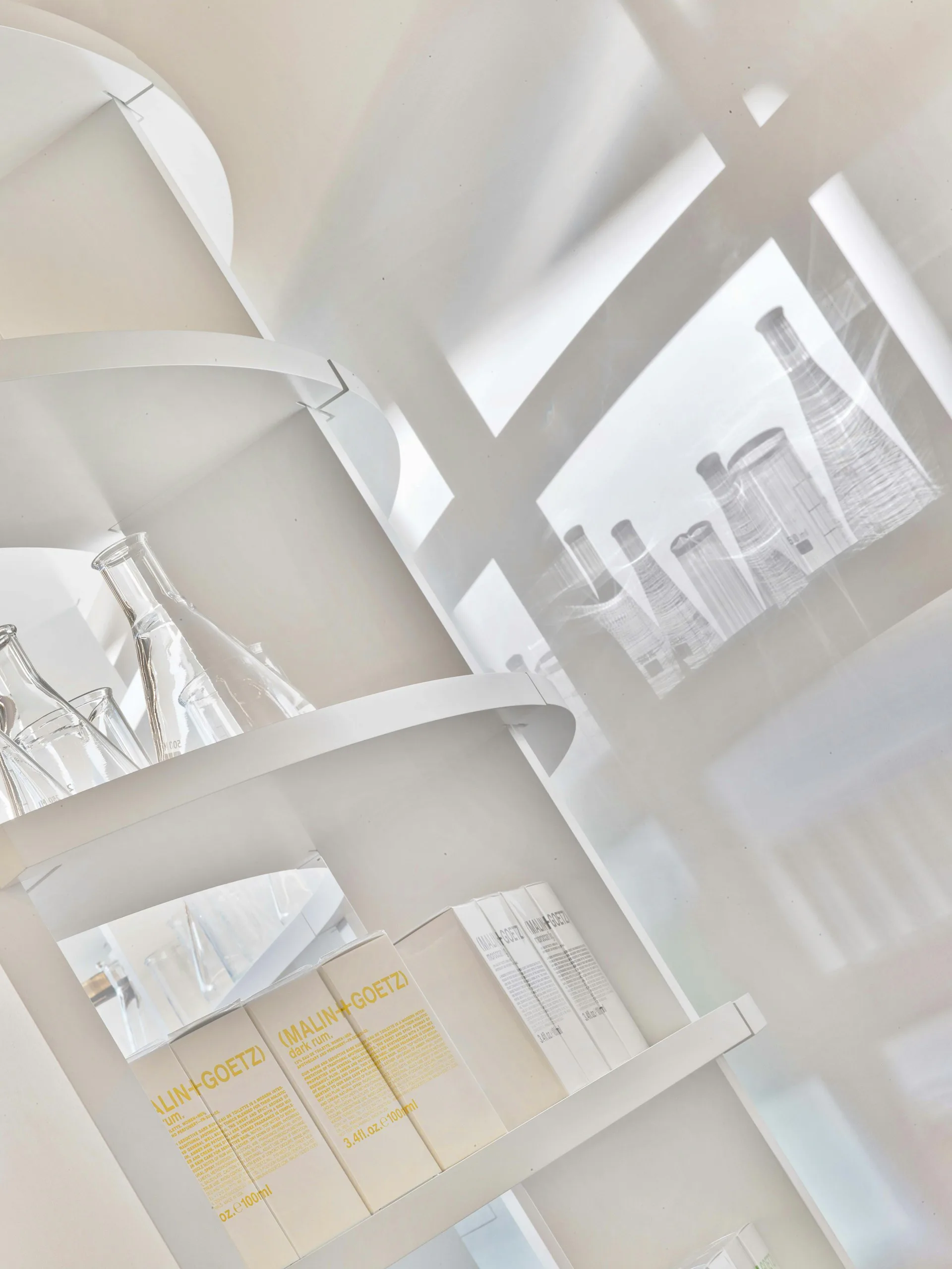 Architectural models and drawings arranged on a light surface, featuring white study models, building sketches, and design layouts by Messana O'Rorke.