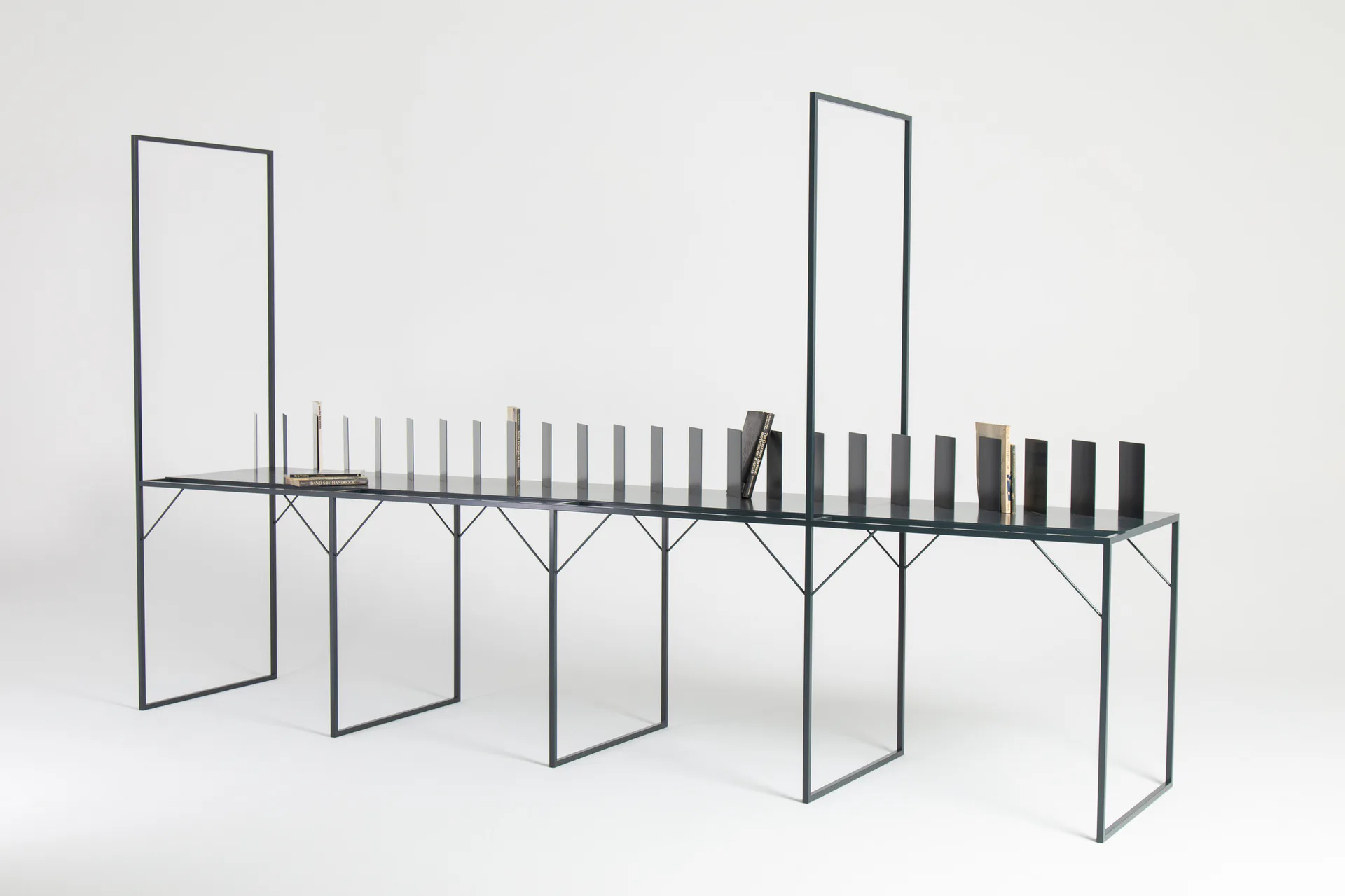 Wire-frame architectural model of a linear structure with vertical panels and posts, rendered in clean lines against a neutral background by Metalform Studio.