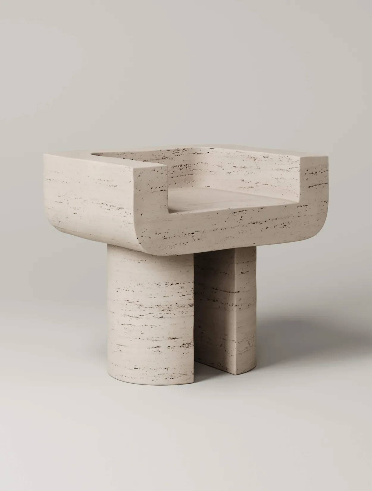 Sculptural travertine chair with curved bowl-like seat and cylindrical pedestal base in cream and taupe tones by Monolith.