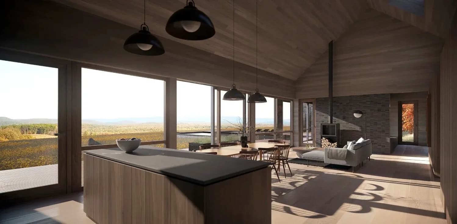 Modern open-plan interior with dark island kitchen, wood ceilings, and expansive windows overlooking landscape by MOREMAS.