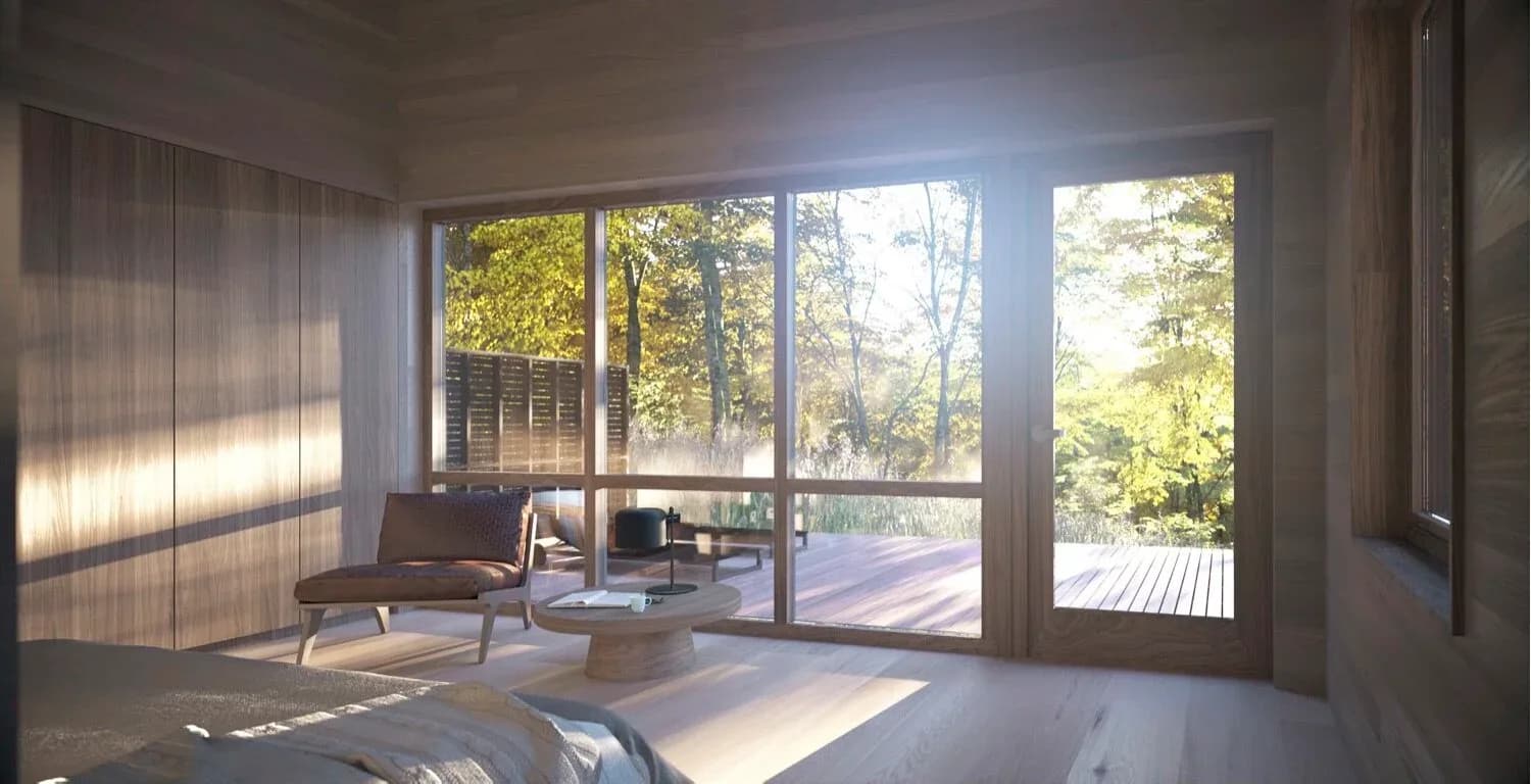 Bright modern bedroom with floor-to-ceiling windows overlooking forest, minimalist furnishings, and natural wood accents by MOREMAS.