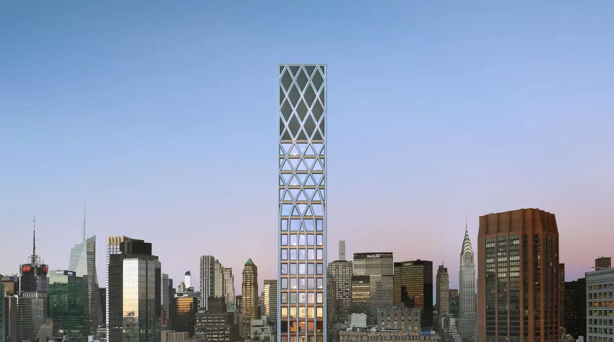 Tall slender residential tower with a latticed diamond pattern facade rising above the Manhattan skyline at dusk, designed by Morris Adjmi Architects.