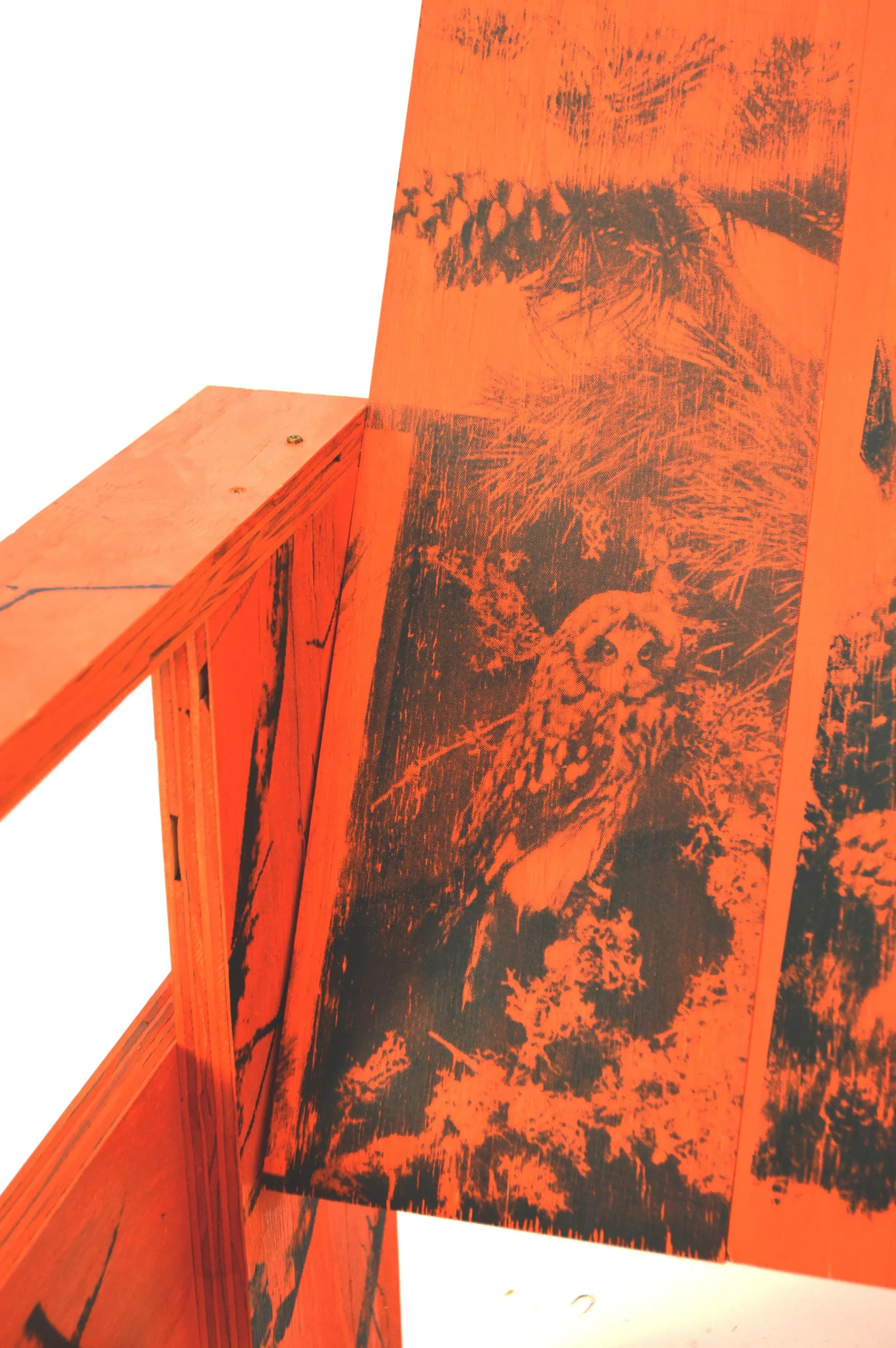 Vibrant orange architectural installation or art piece with abstract black imagery and geometric forms, featuring a folded structural element by MTM Studio.