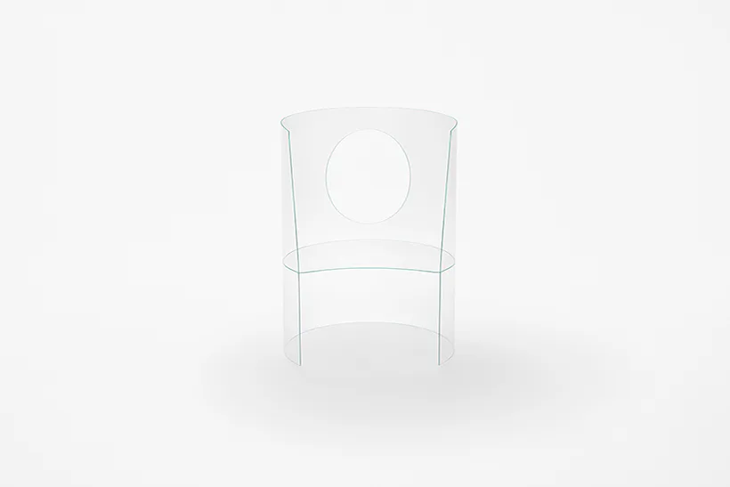 Minimalist wireframe chair design with circular backrest detail shown against neutral background by nendo.