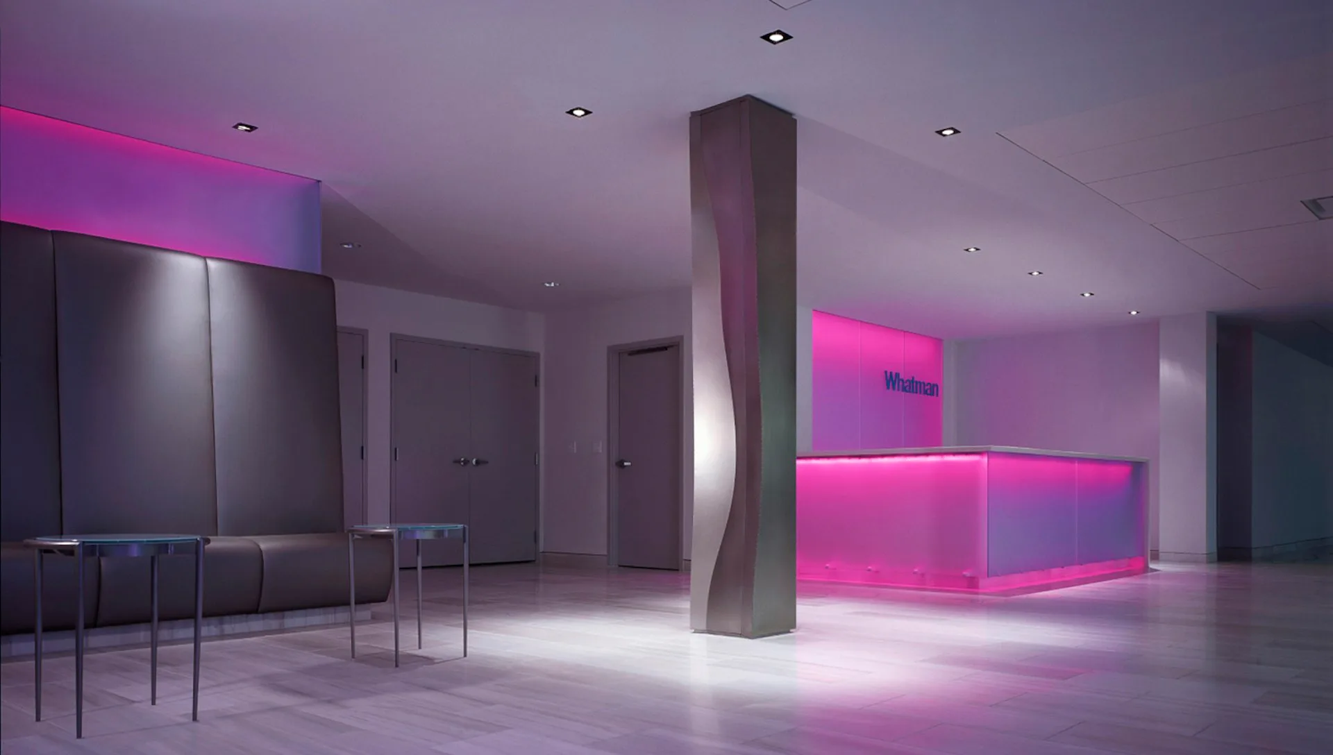 Modern interior space with magenta neon lighting, concrete column, minimalist furniture, and polished floors by NK Architects.