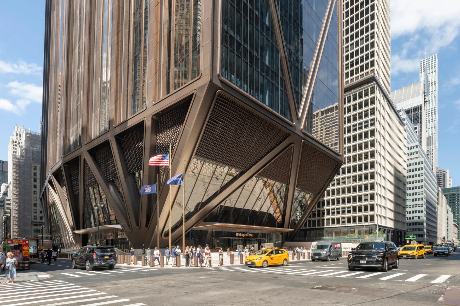 Bronze sculptural canopy with geometric lattice framework anchors a Chicago street corner, flanked by towering modernist skyscrapers and yellow cabs, by Practice for Architecture and Urbanism.