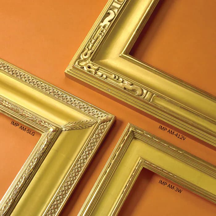 Golden decorative picture frames with ornate detailing arranged against warm orange background, showcasing frame styles and finishes by Rhonda Feinman Custom Frames, Inc.