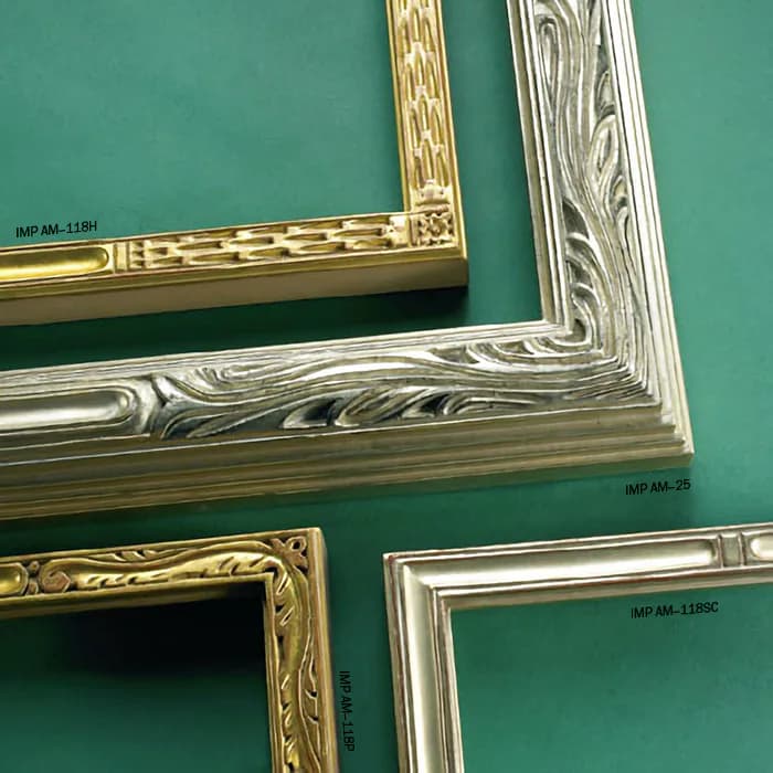 Decorative picture frame samples in gold, silver, and wood finishes displayed against a green wall, showcasing ornamental molding designs by Rhonda Feinman Custom Frames, Inc.