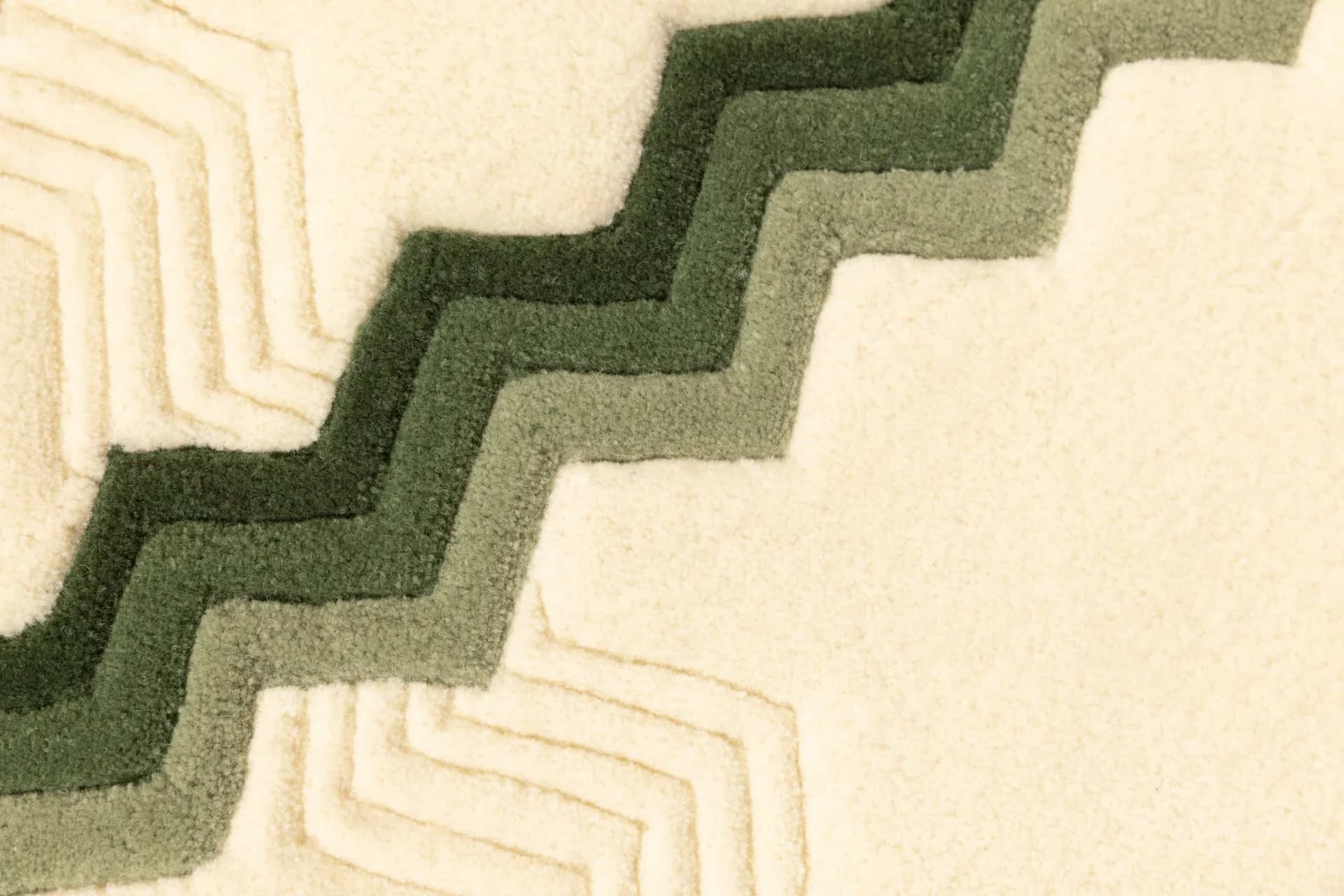 Minimalist landscape design featuring geometric maze patterns in contrasting green and cream tones, creating visual rhythm through layered hedging by Rhyme Studio.