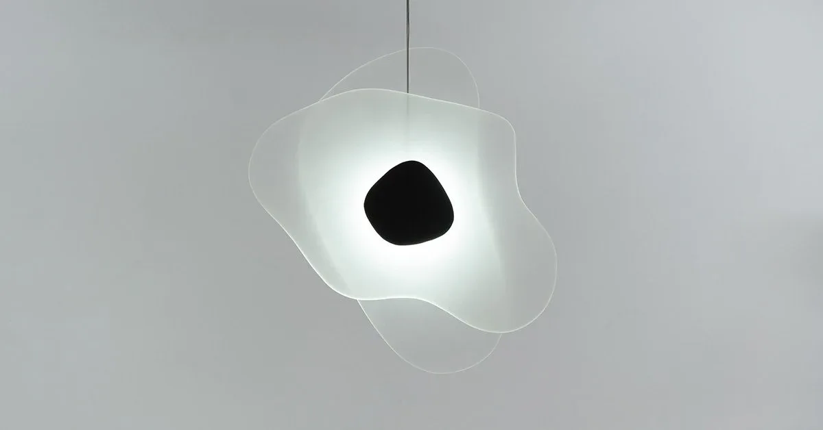 Translucent sculptural pendant light with organic, cloud-like form and black spherical interior element, illuminated from within by Richard Clarkson Studio.