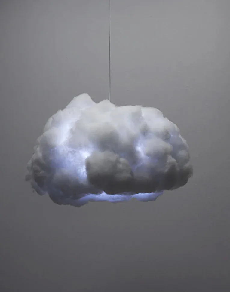 Illuminated cloud-like sculpture suspended from above with soft white and blue LED lighting creating a glowing ethereal effect by Richard Clarkson Studio.