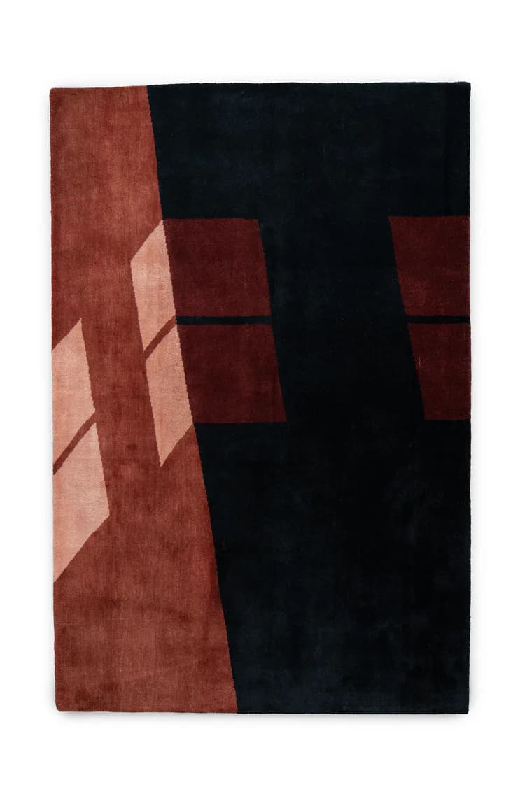 Contemporary wool area rug with geometric design featuring deep charcoal black and burgundy red blocks with dimensional layered elements, by Ridezign.