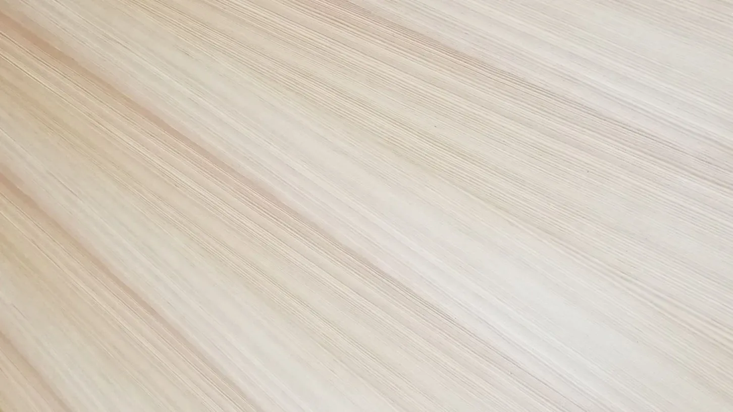 Close-up detail of light wood flooring with diagonal planks in warm cream and tan tones by Robert Kalka Custom Woodworking.