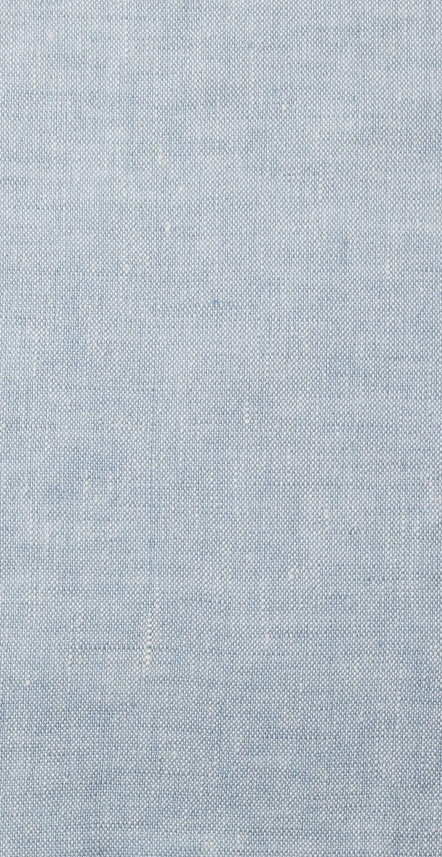 Close-up of light blue textured fabric or upholstery material with fine woven pattern, showcasing material selection by Rogers & Goffigon.