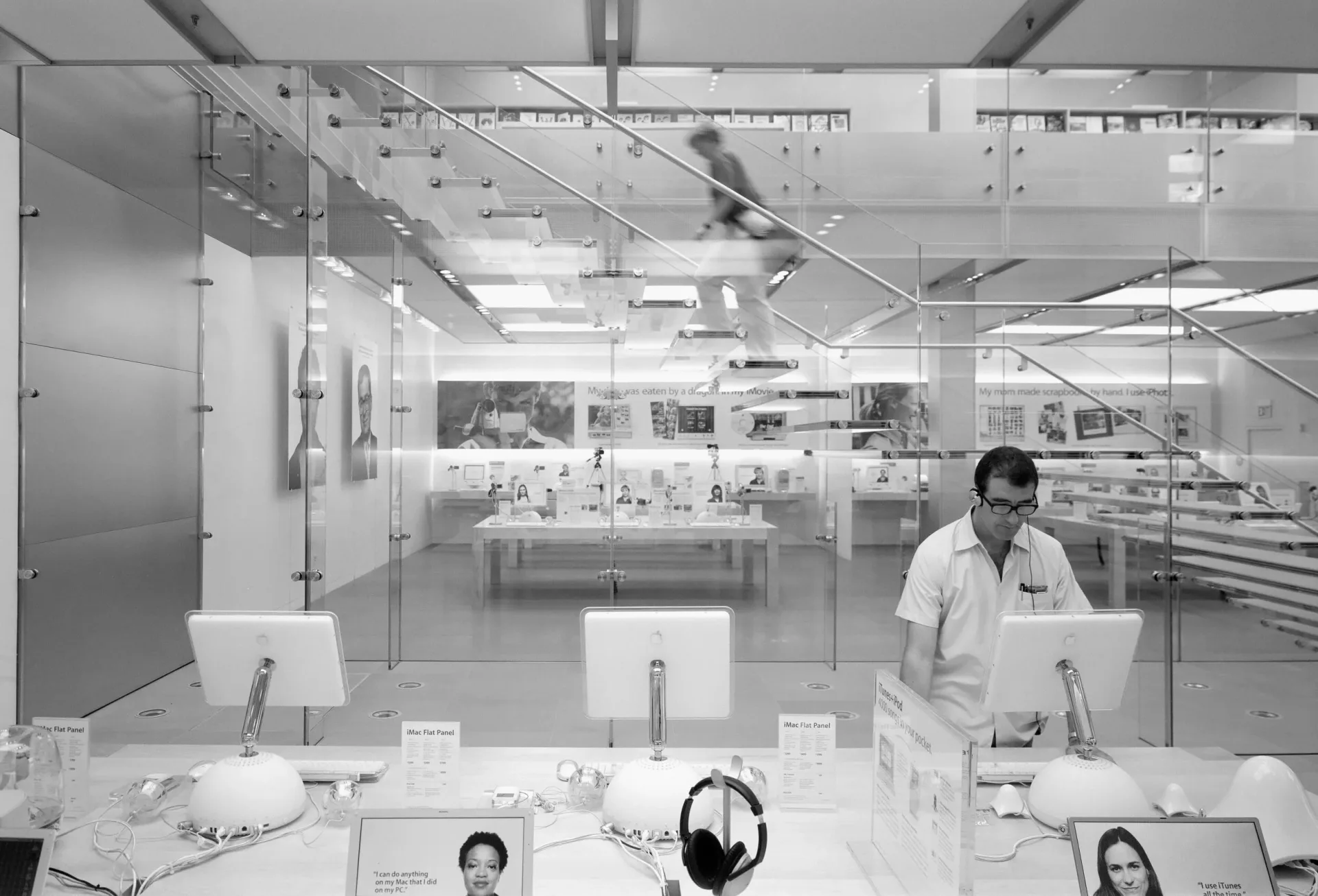 Modern laboratory or showroom with glass partitions, white surfaces, and minimal furnishings, featuring bright overhead lighting and clean aesthetic by Ronnette Riley Architect.