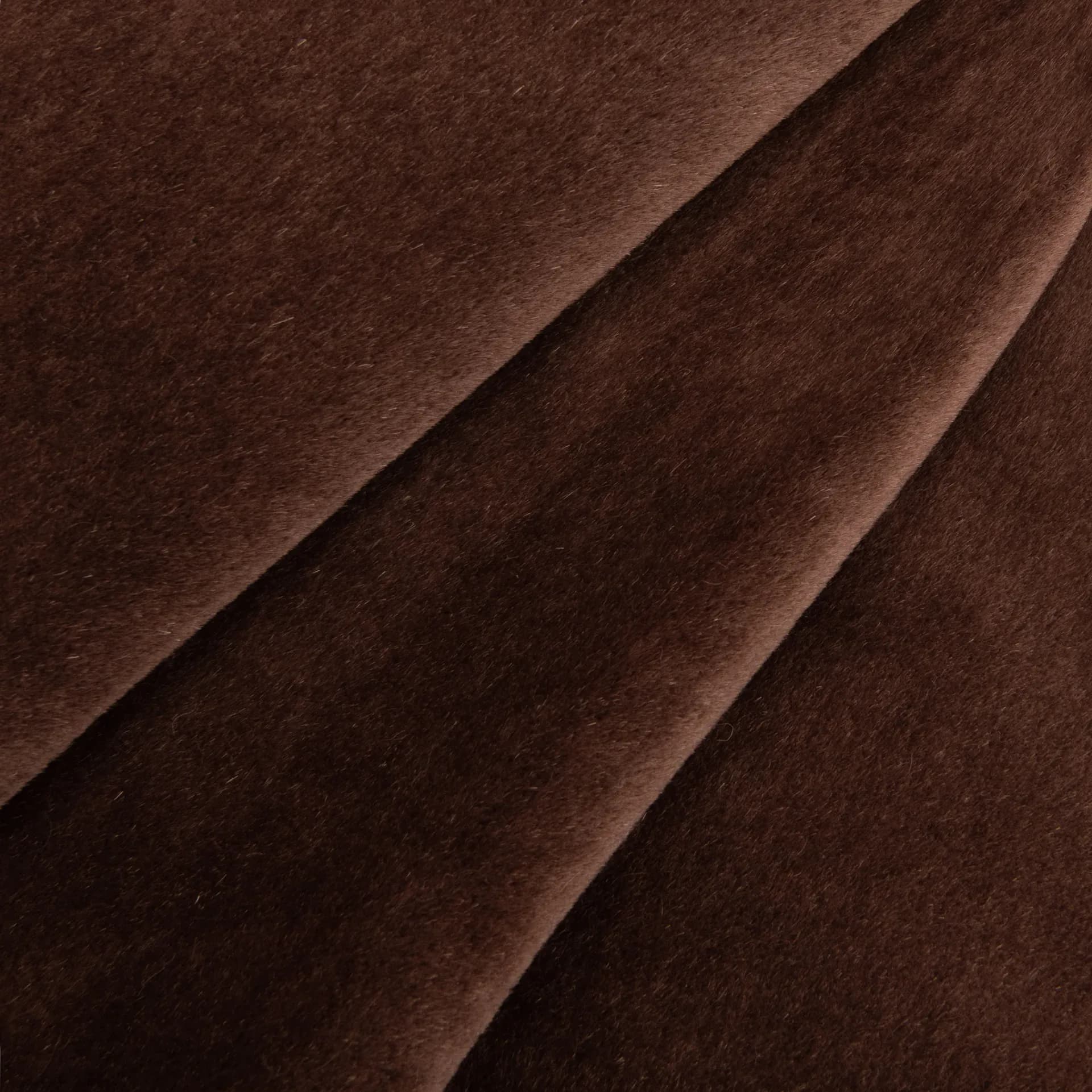 Close-up detail of rich brown velvet fabric with subtle folds and directional draping, showcasing material selection and texture by Rosemary Hallgarten.