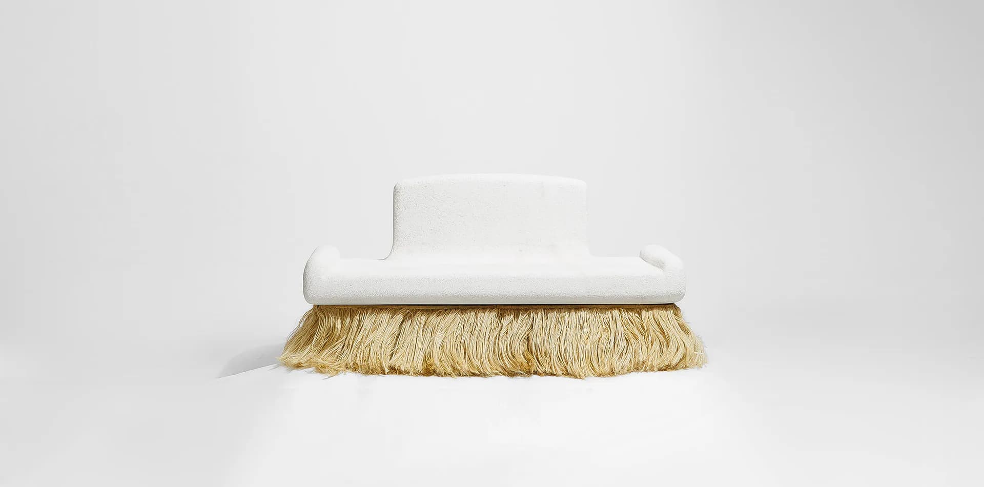 Minimalist white sculptural brush form with natural straw bristles on neutral background by Sayar & Garibeh.