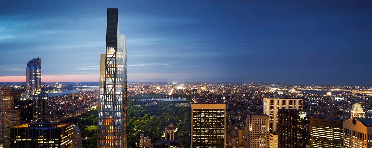 Twilight cityscape of Manhattan skyscrapers with dramatic blue sky, architectural lighting design highlighting a tall slender tower by Schwinghammer Lighting.