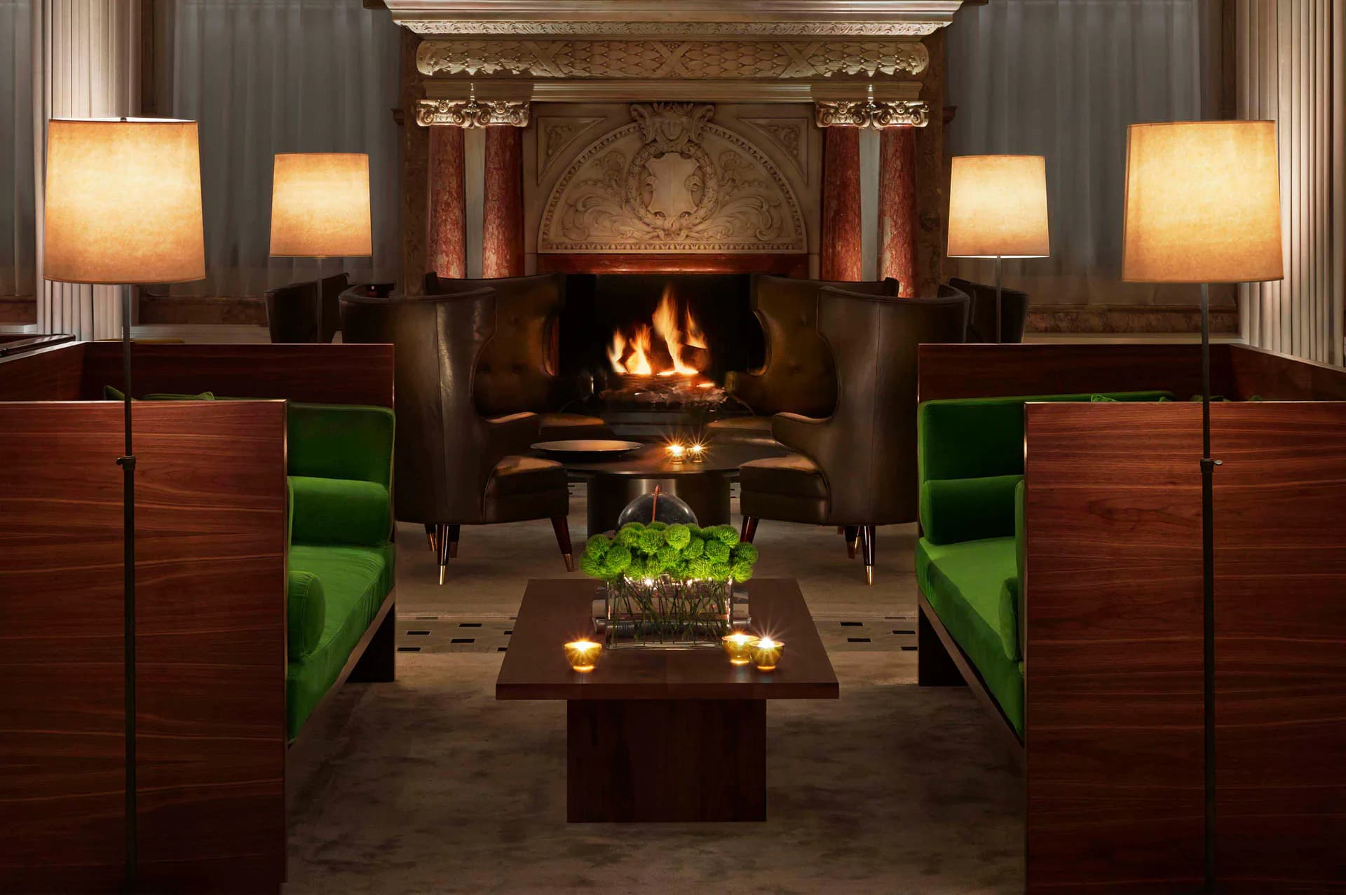 Luxury lounge interior with fireplace, warm wood paneling, green velvet seating, glowing table lamps, and classical architectural details by SENTIENT.
