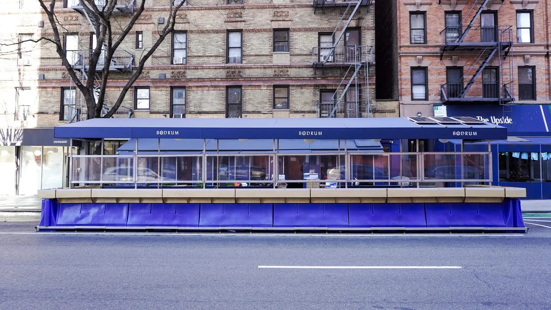 Blue storefront with expansive glazing and horizontal window banding on a New York City street, designed by SITU.