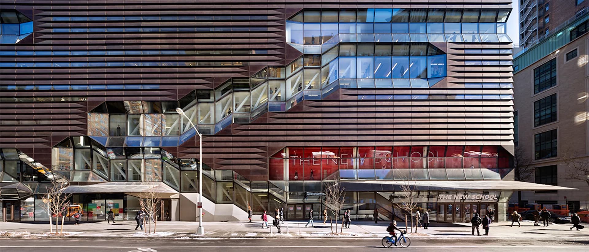 Contemporary urban plaza with horizontal wood-slat facade, glass storefront, and pedestrians by Skidmore, Owings & Merrill (SOM).