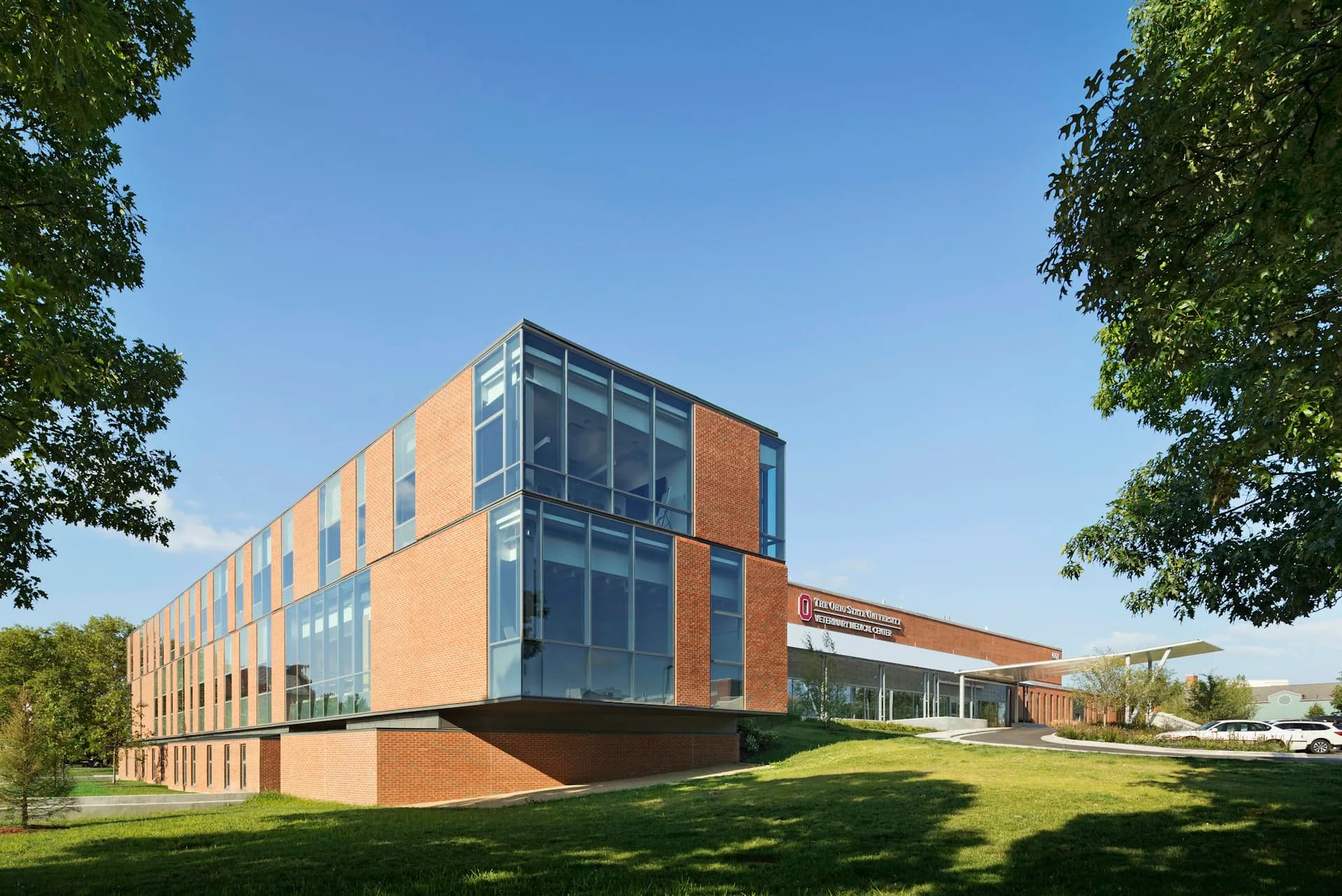 Modern institutional building with orange brick and glass facade set on manicured lawn, designed by Smith-Miller + Hawkinson Architects LLP.