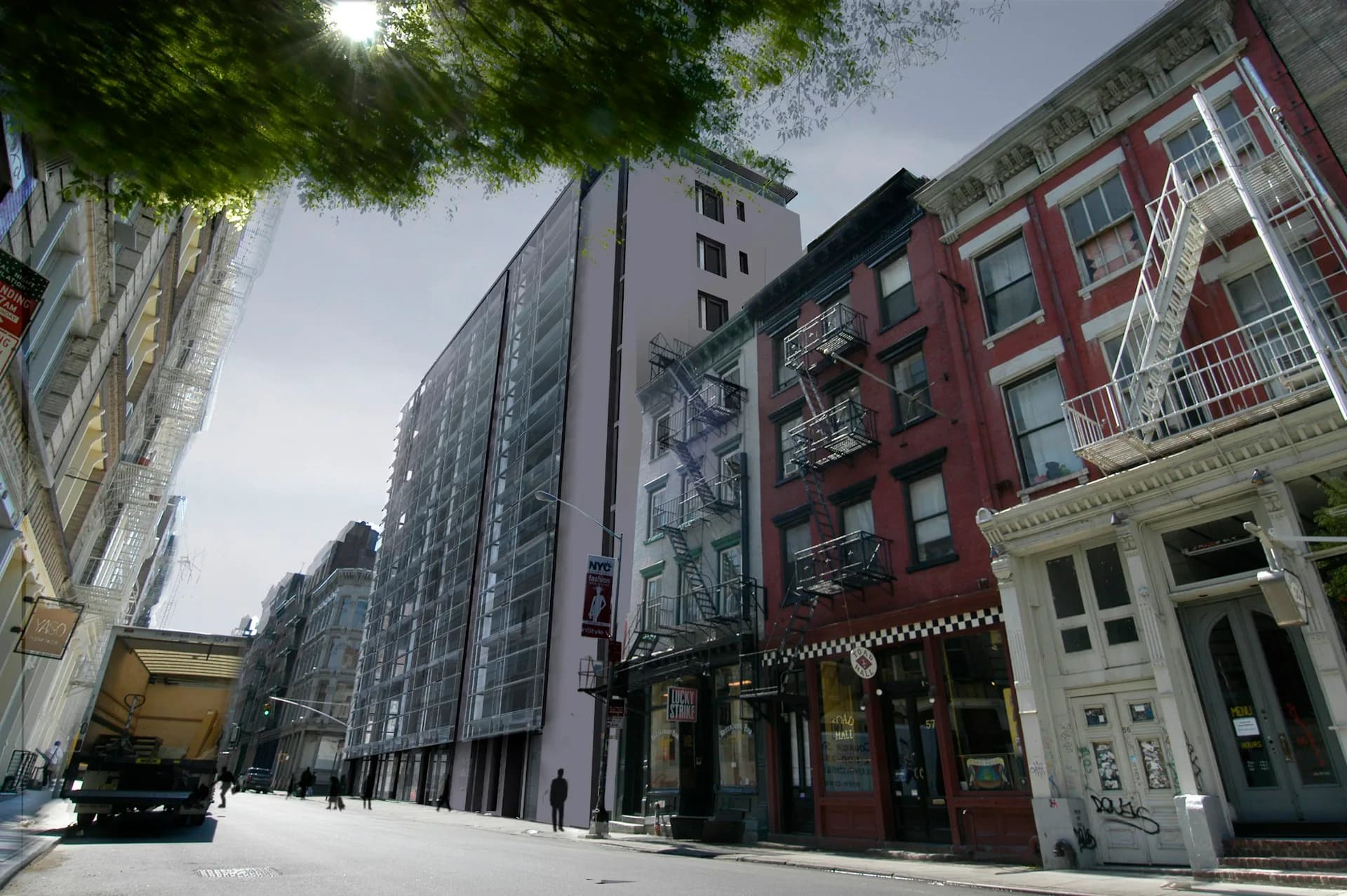 Urban street-level view of mixed-use buildings featuring a modern dark glass facade alongside a restored historic red brick building, designed by Smith-Miller + Hawkinson Architects LLP.