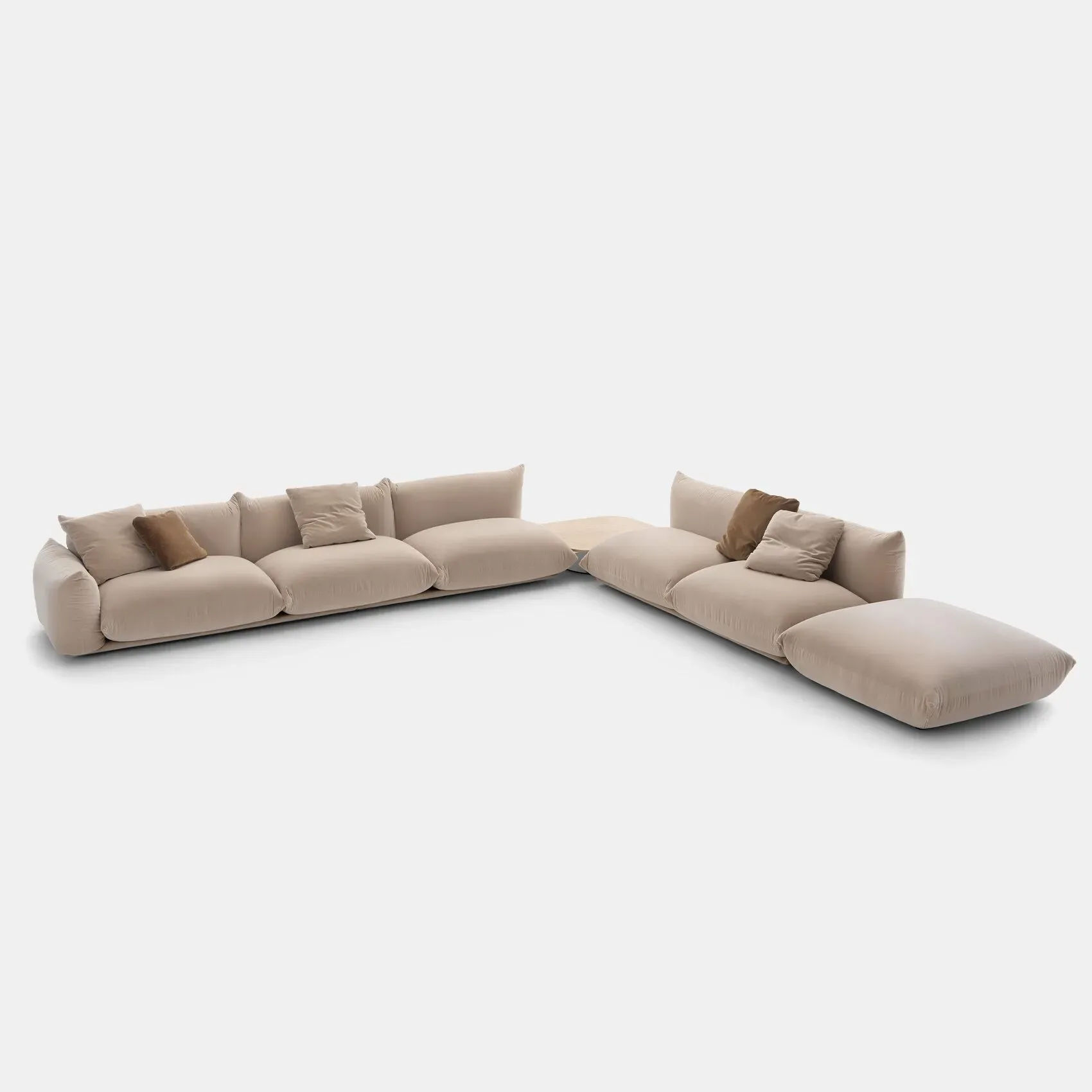 Beige modular sectional sofa with organic curved forms and scattered cushions against neutral background by The Future Perfect.