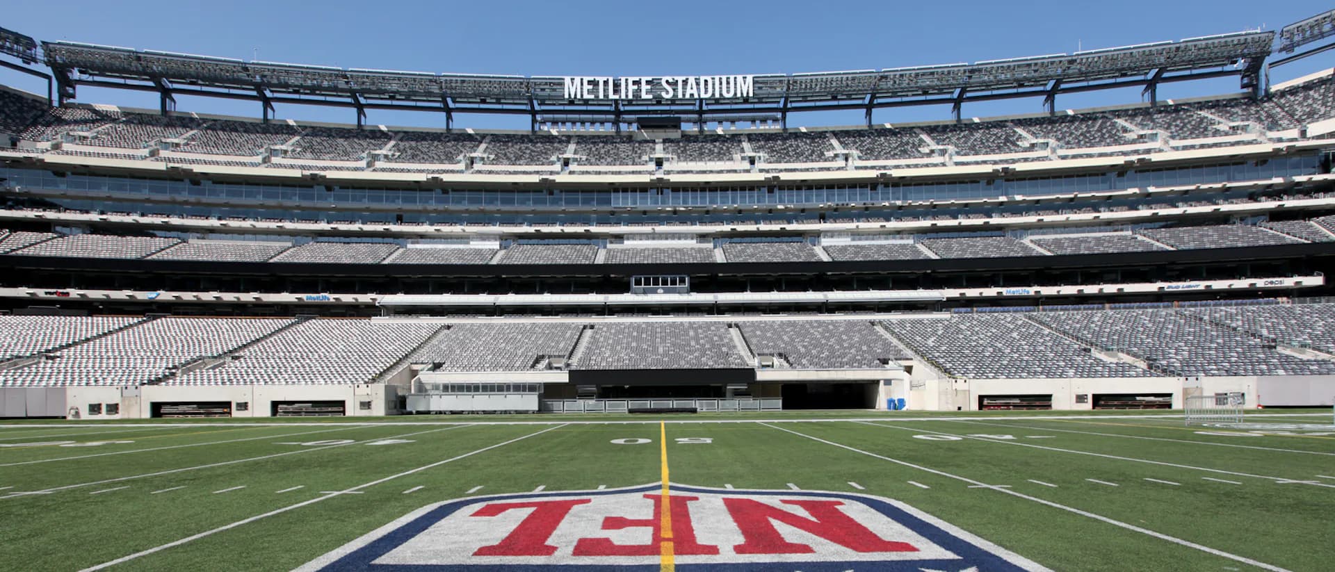 MetLife Stadium field with NFL logo, showing architectural structural elements and seating bowl designed by Thornton Tomasetti.