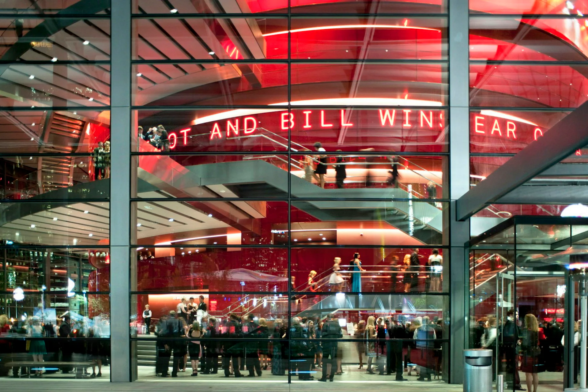 Modern red-lit interior with glass storefront, steel structural elements, and neon signage creating a contemporary retail or hospitality space by Thornton Tomasetti.