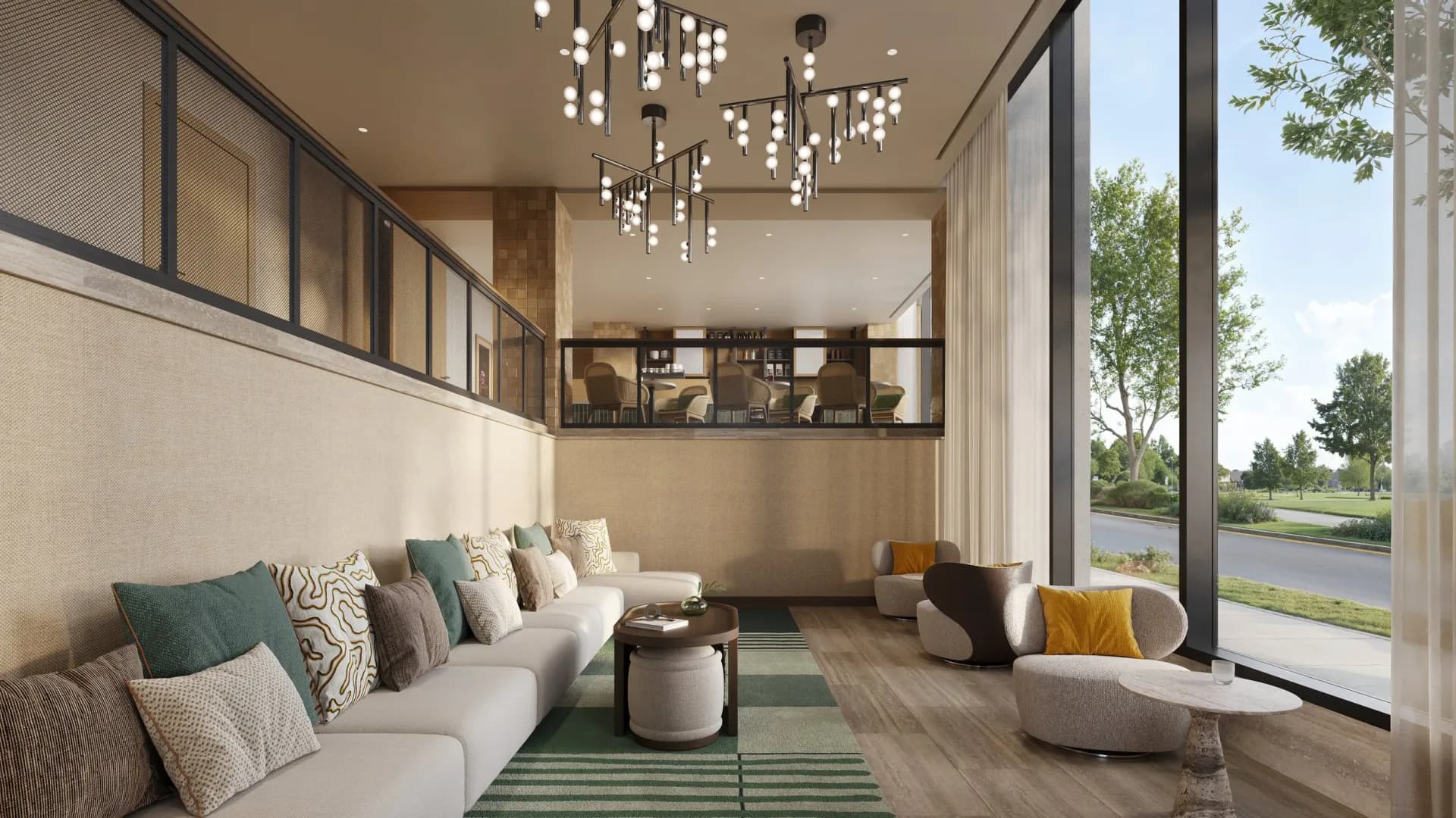Contemporary living room with cream sectional sofa, green area rug, and floor-to-ceiling windows overlooking landscape; interior by Tirschwell & Co.