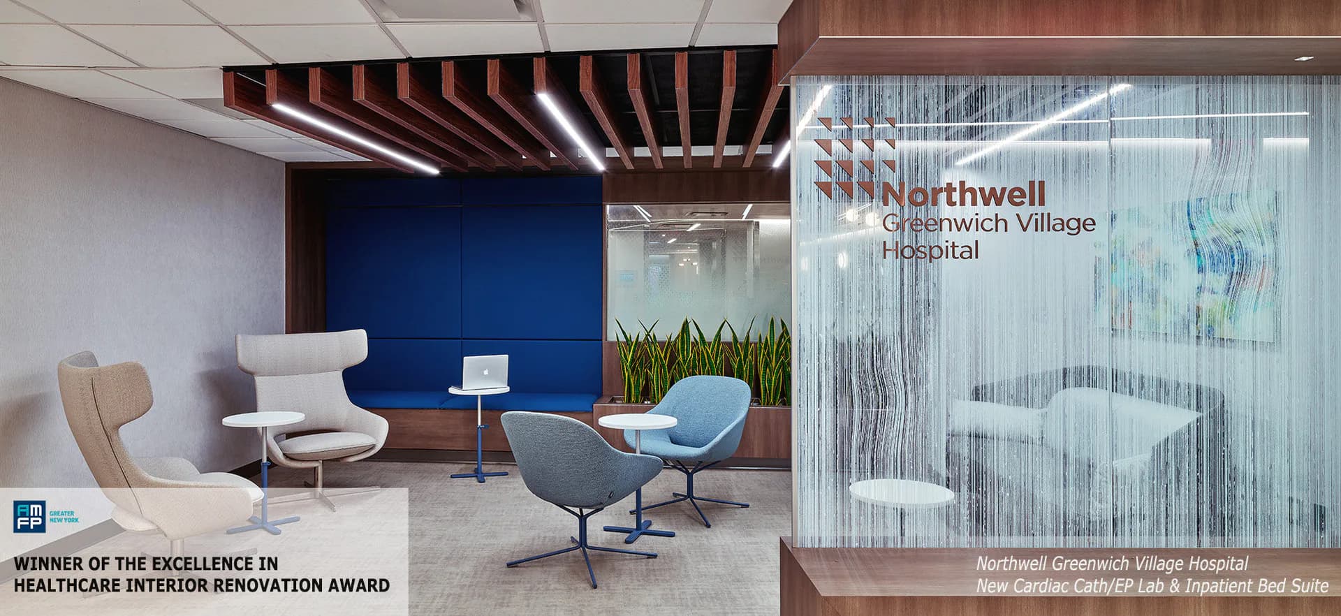 Modern healthcare waiting area with blue accent wall, wood slat ceiling, contemporary lounge seating, and glass partition with Northwell branding by Twine Architectural Studio.